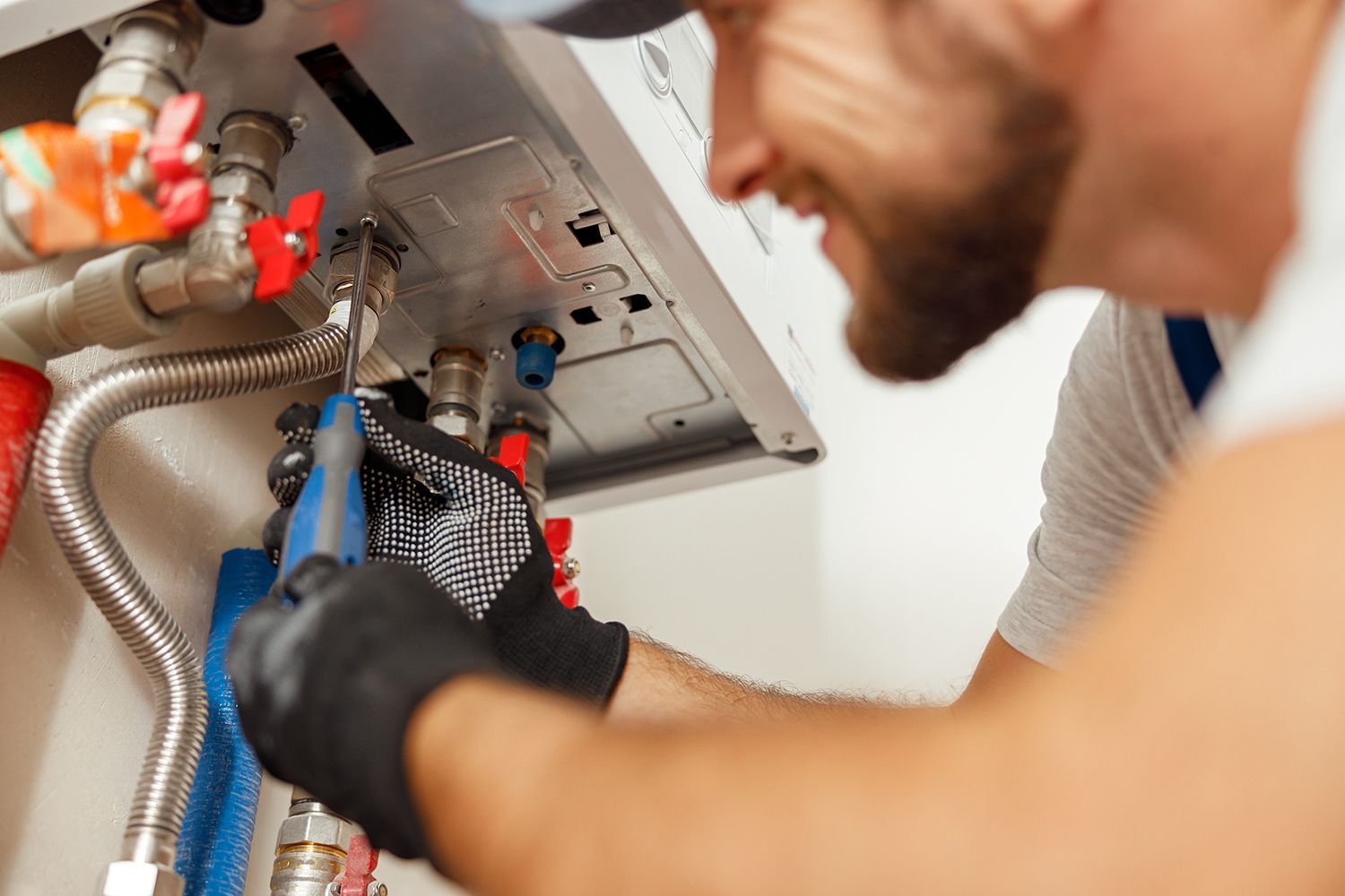 A man is installing a new water heater.