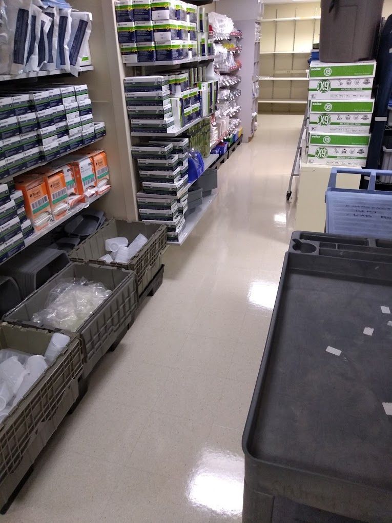 A store aisle filled with lots of boxes and shelves