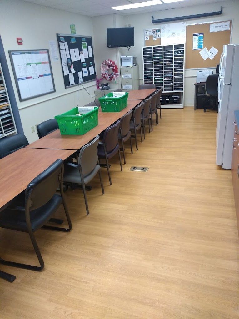 A room with a long table and chairs in it
