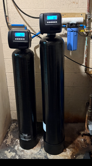 Technician installing a rental reverse osmosis drinking water system under a kitchen sink