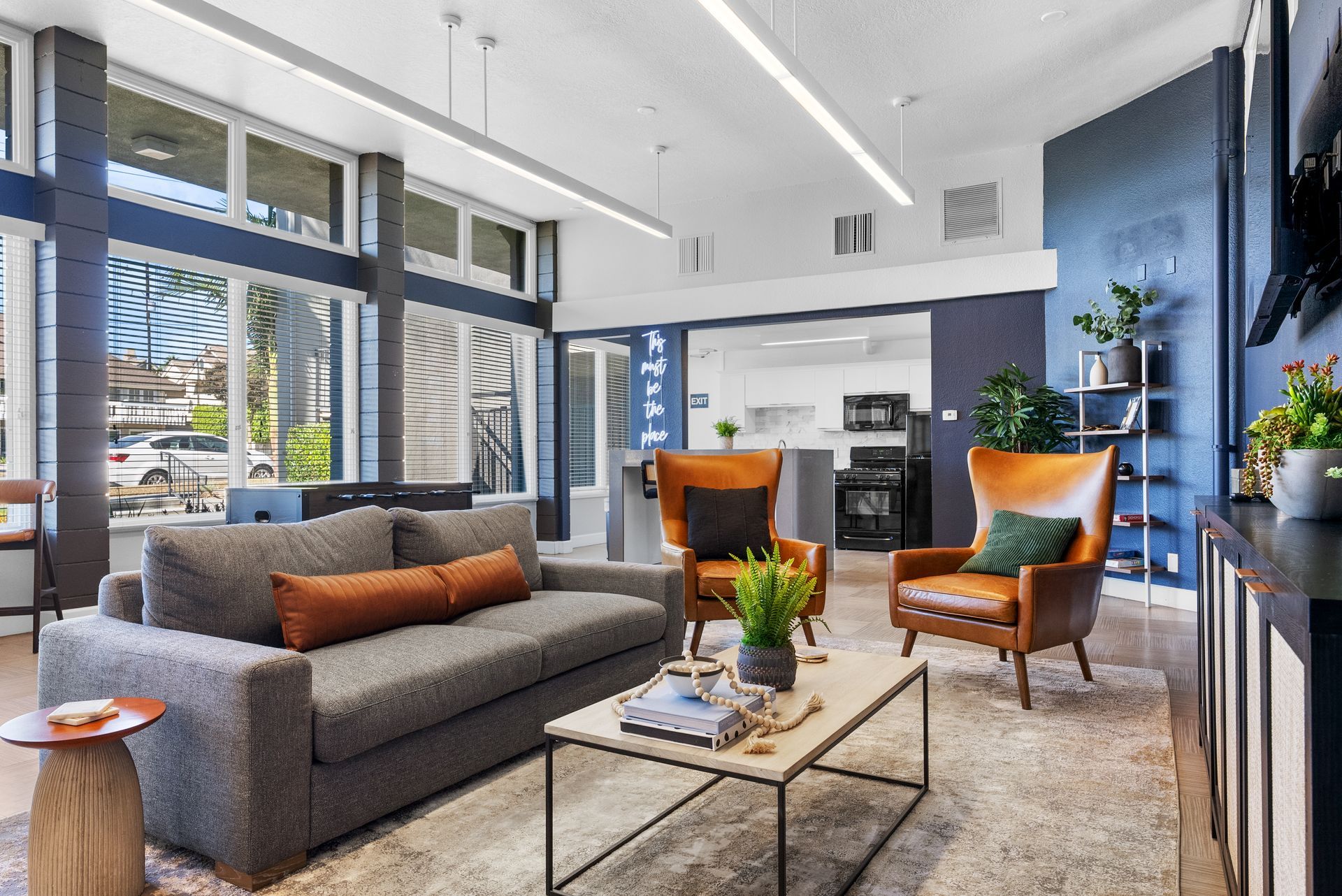 Community room with seating, kitchen, and game table