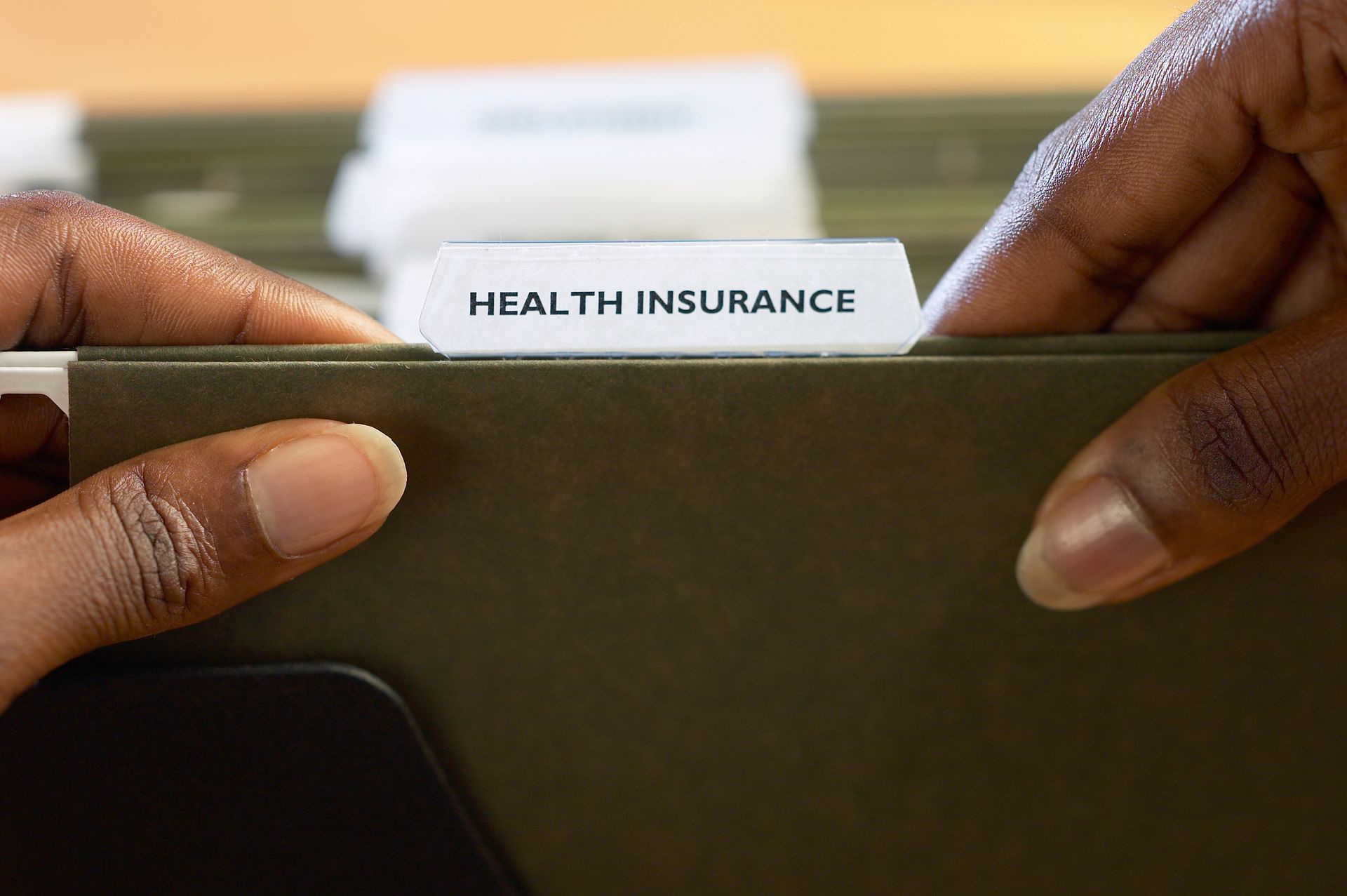 close up of file labeled health insurance