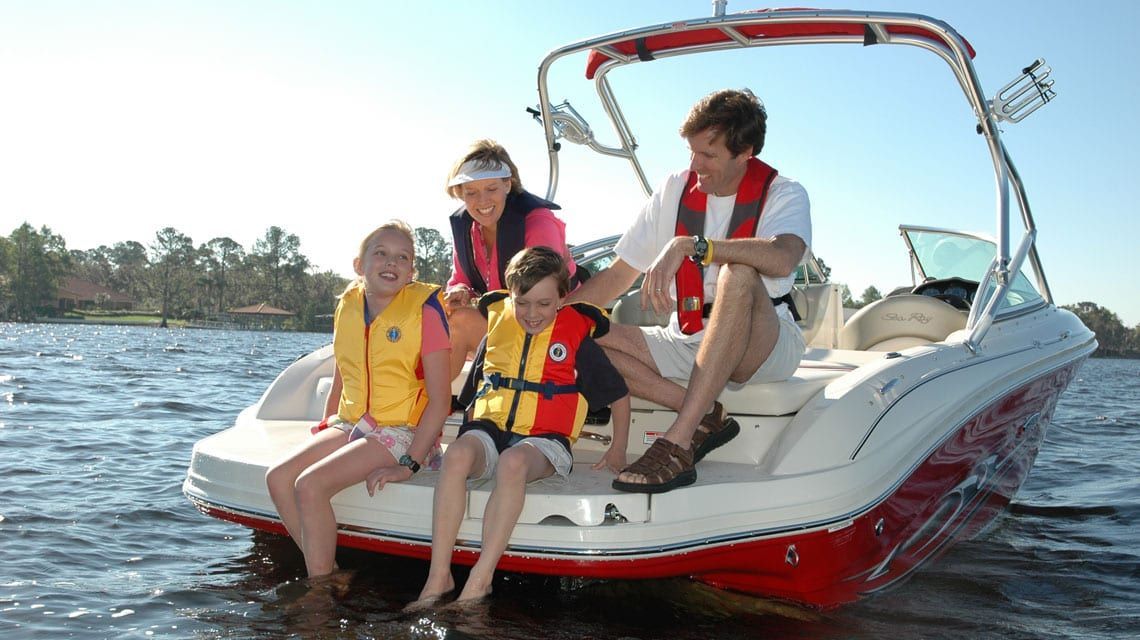 family enjoys boating time with insurance protection