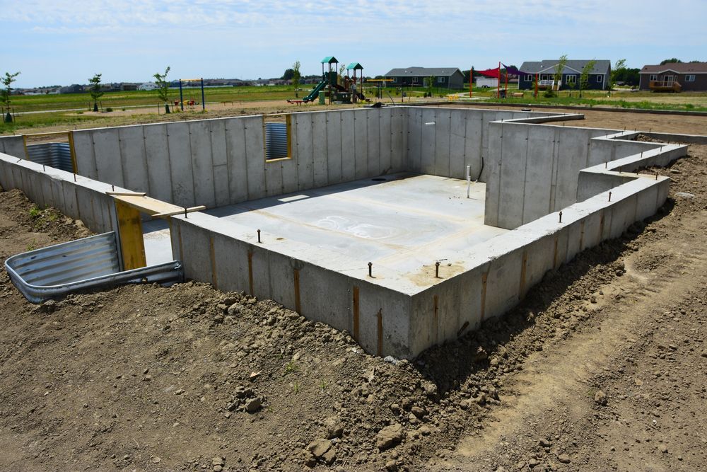 Concrete foundation under construction at a rural building site