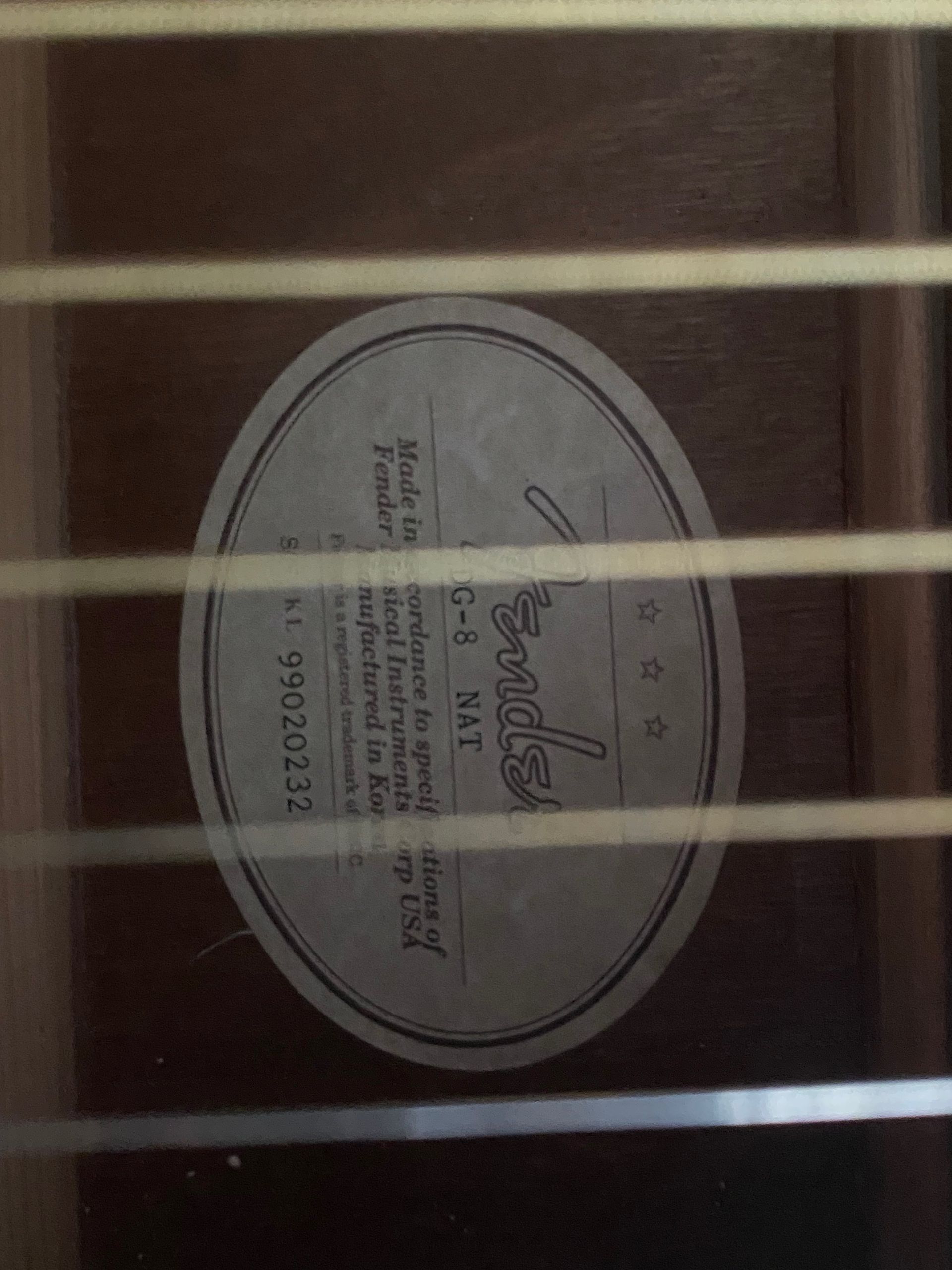 a close up on the hole of an acoustic guitar