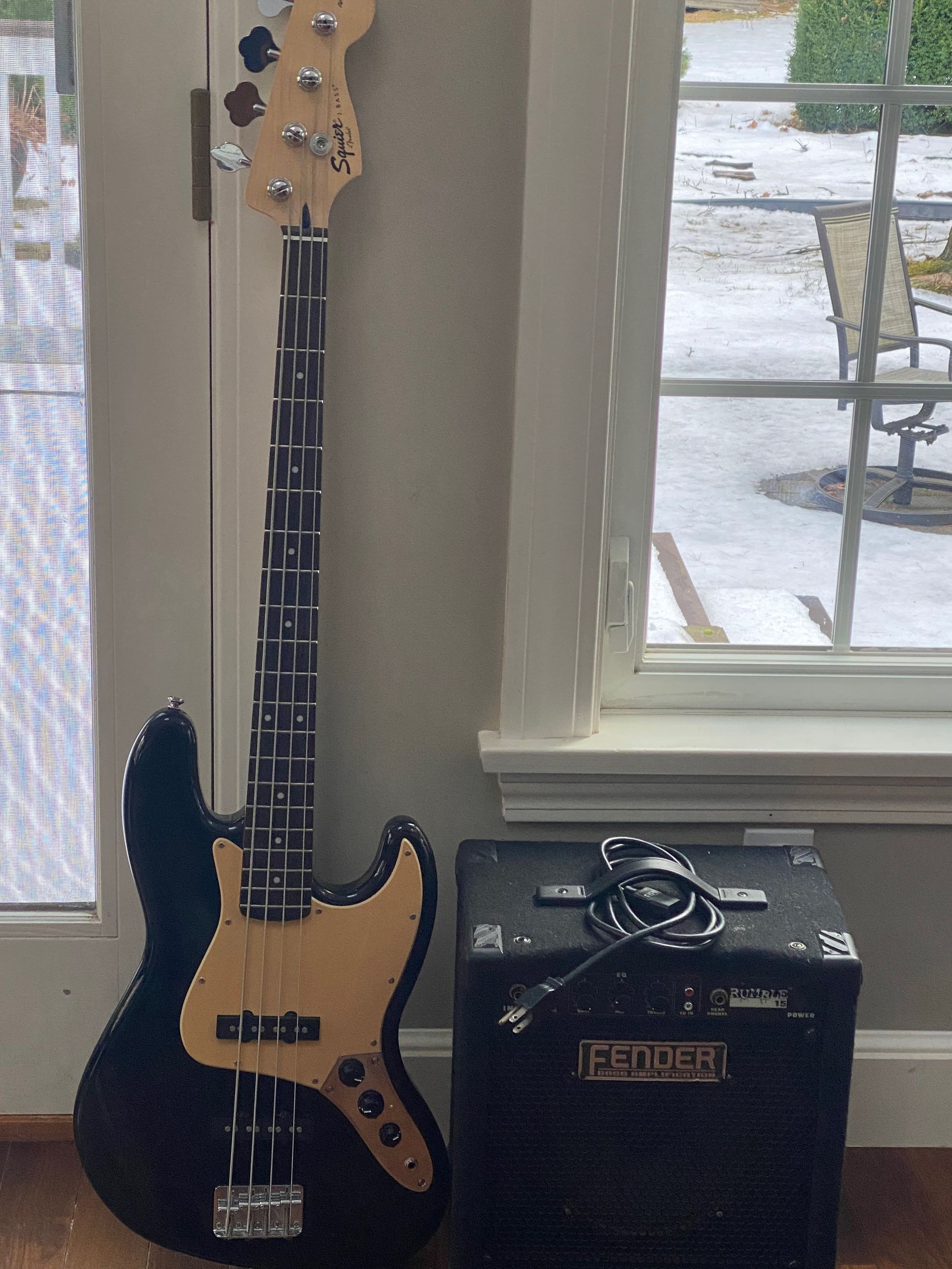 a black bass guitar and an amplifier