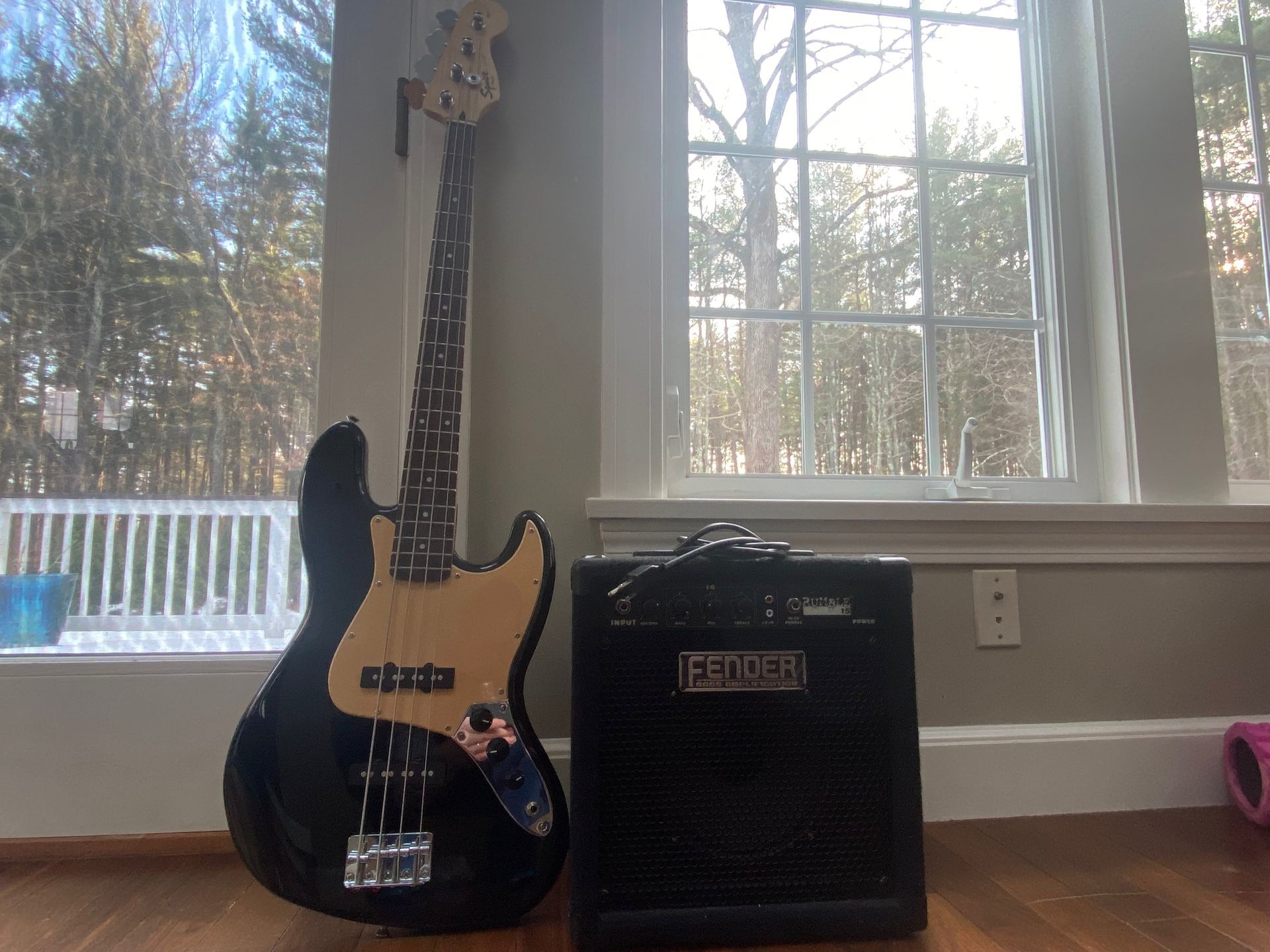 a black bass guitar and an amplifier