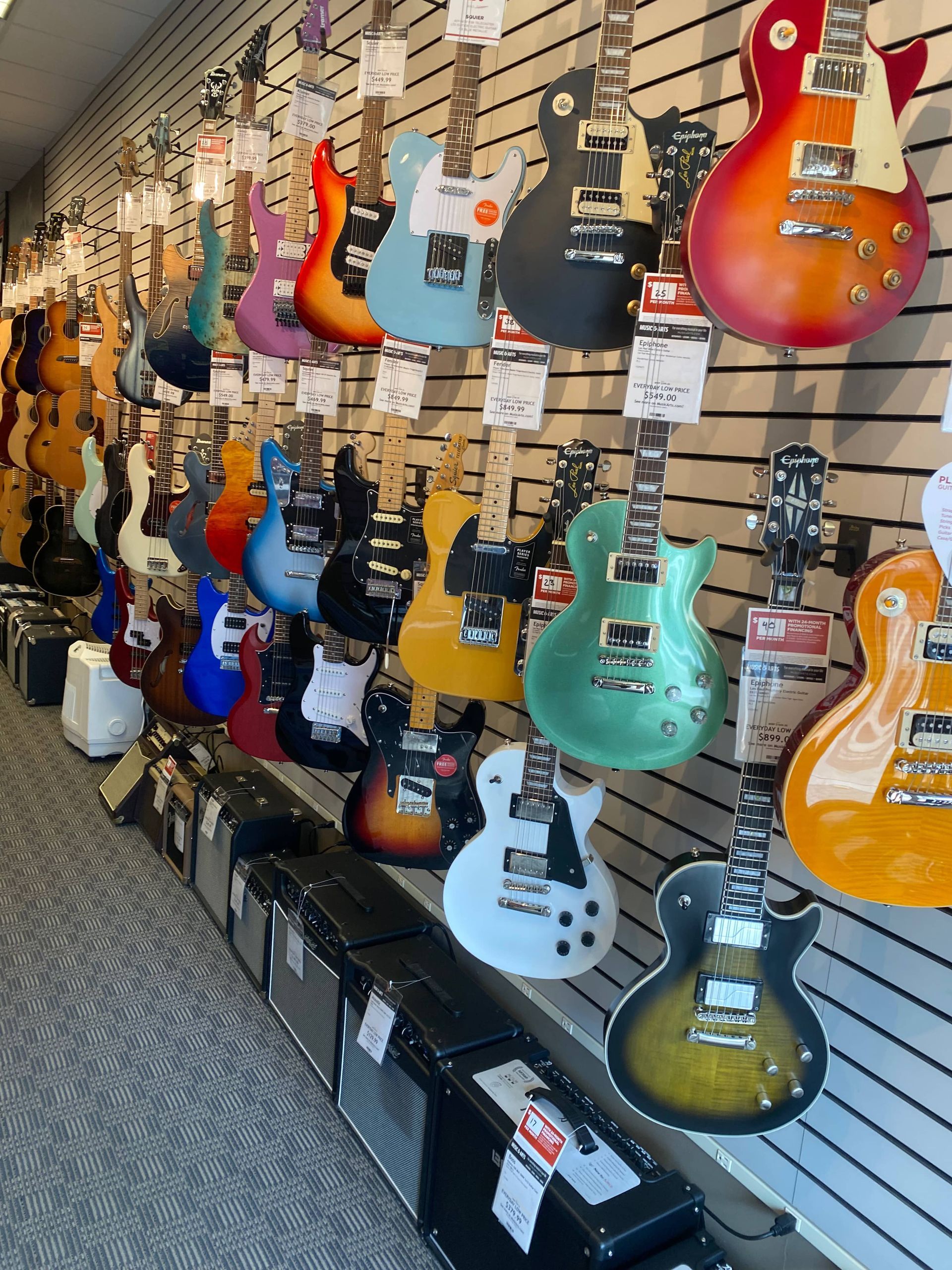 music shop with a wall of electric guitar