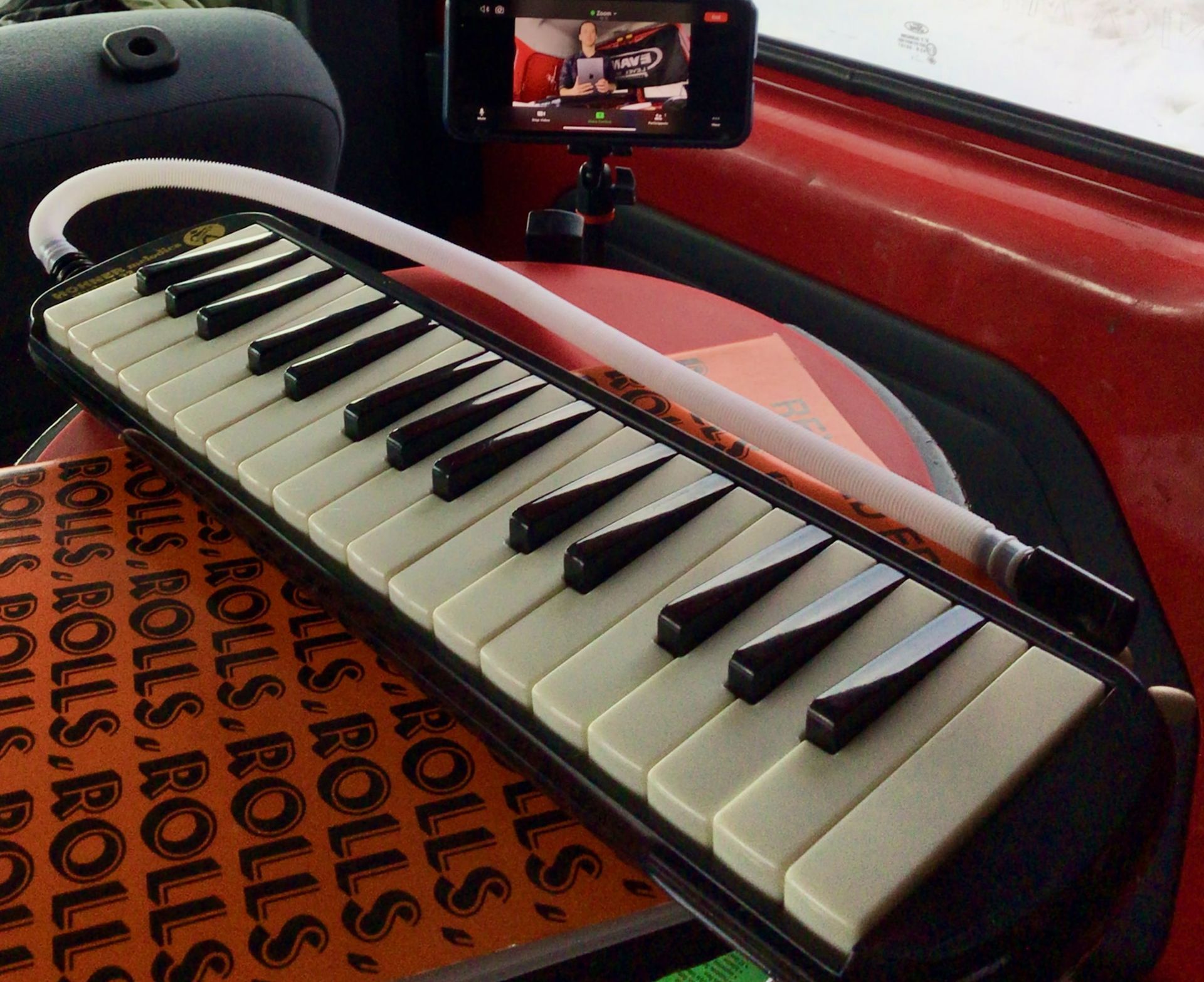 A melodica made of a keyboard or piano with a tube to blow on to