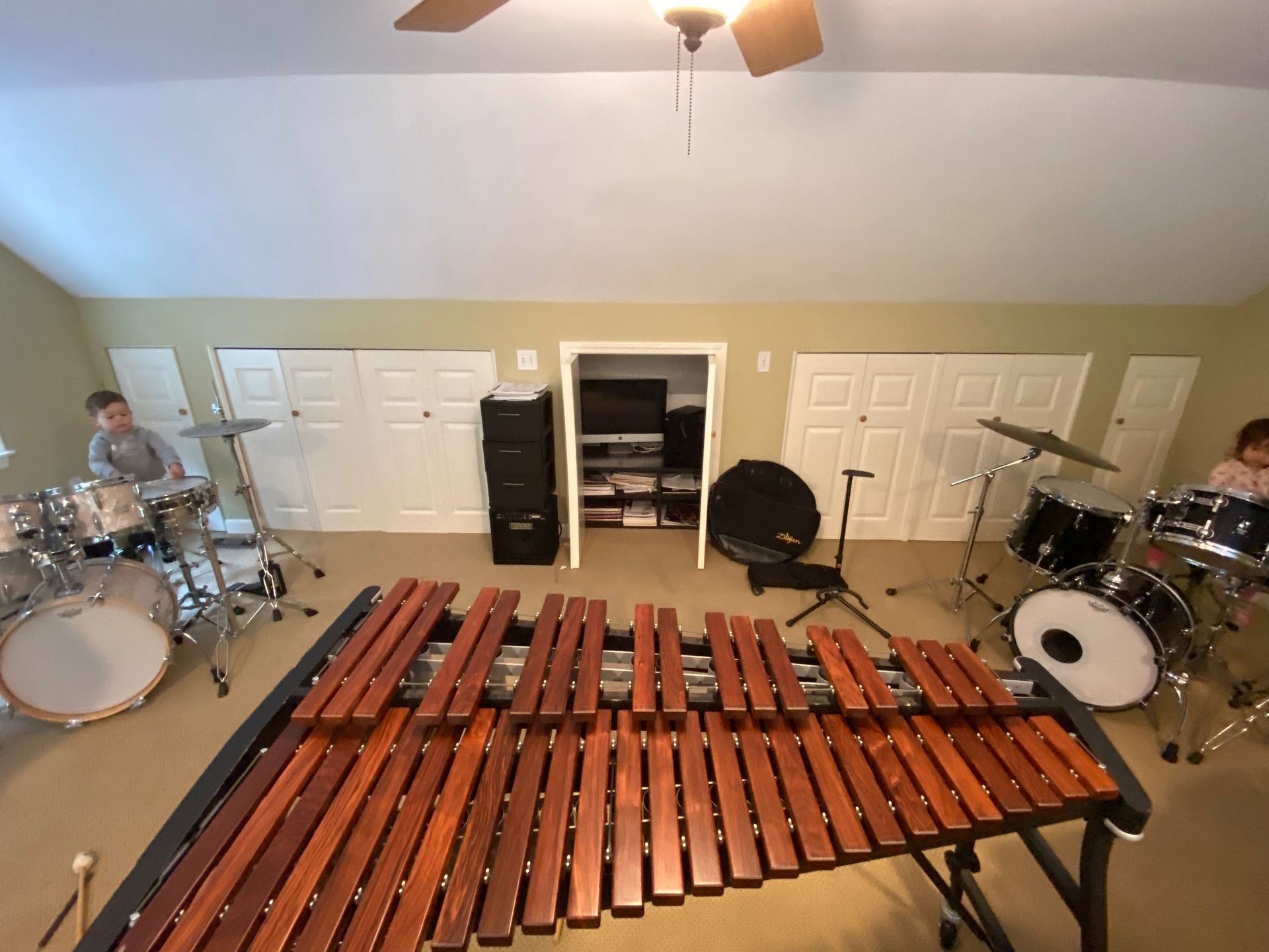 a xylophone on a practice room with two drum sets