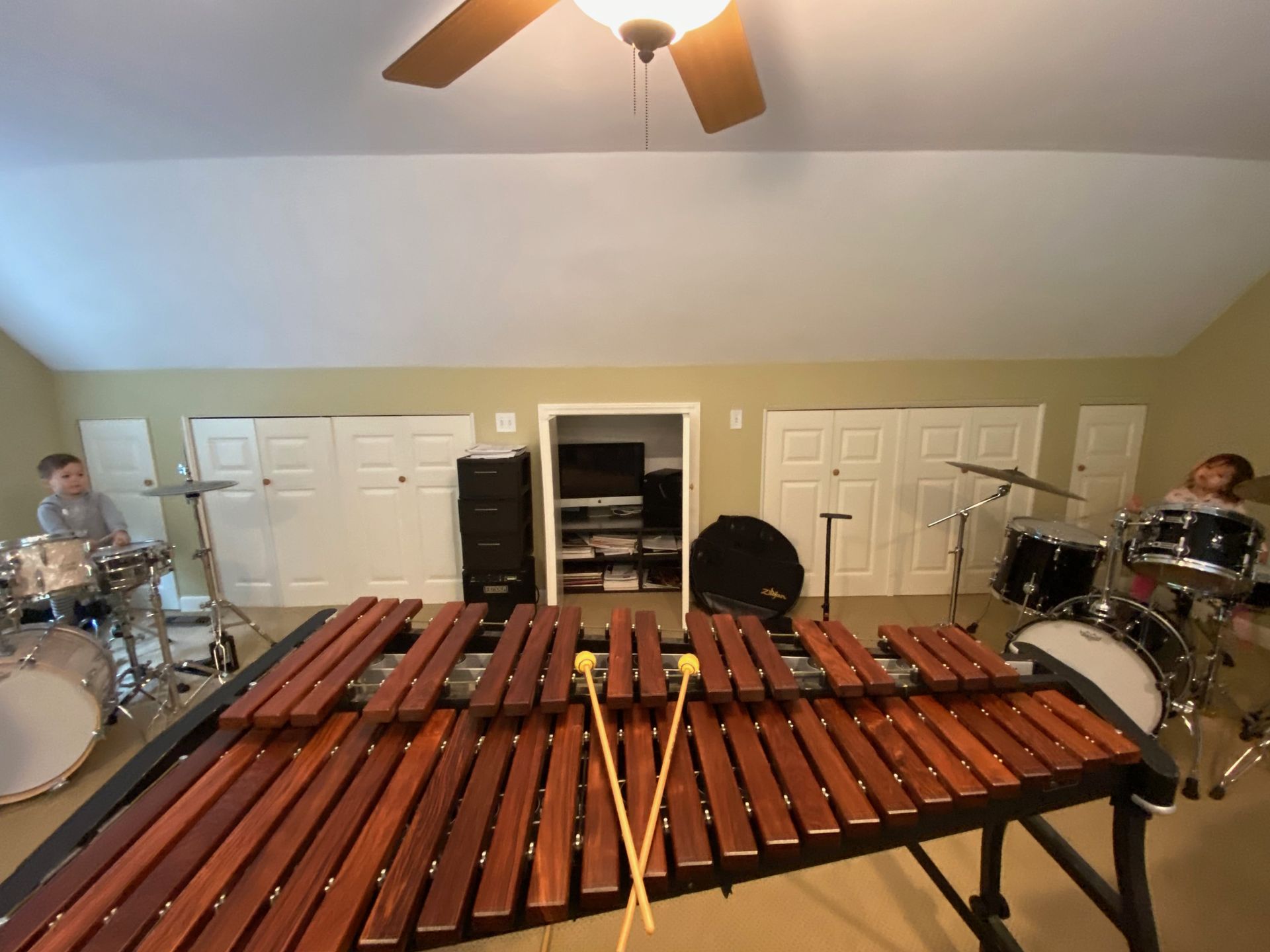 a xylophone on a practice room with two drum sets