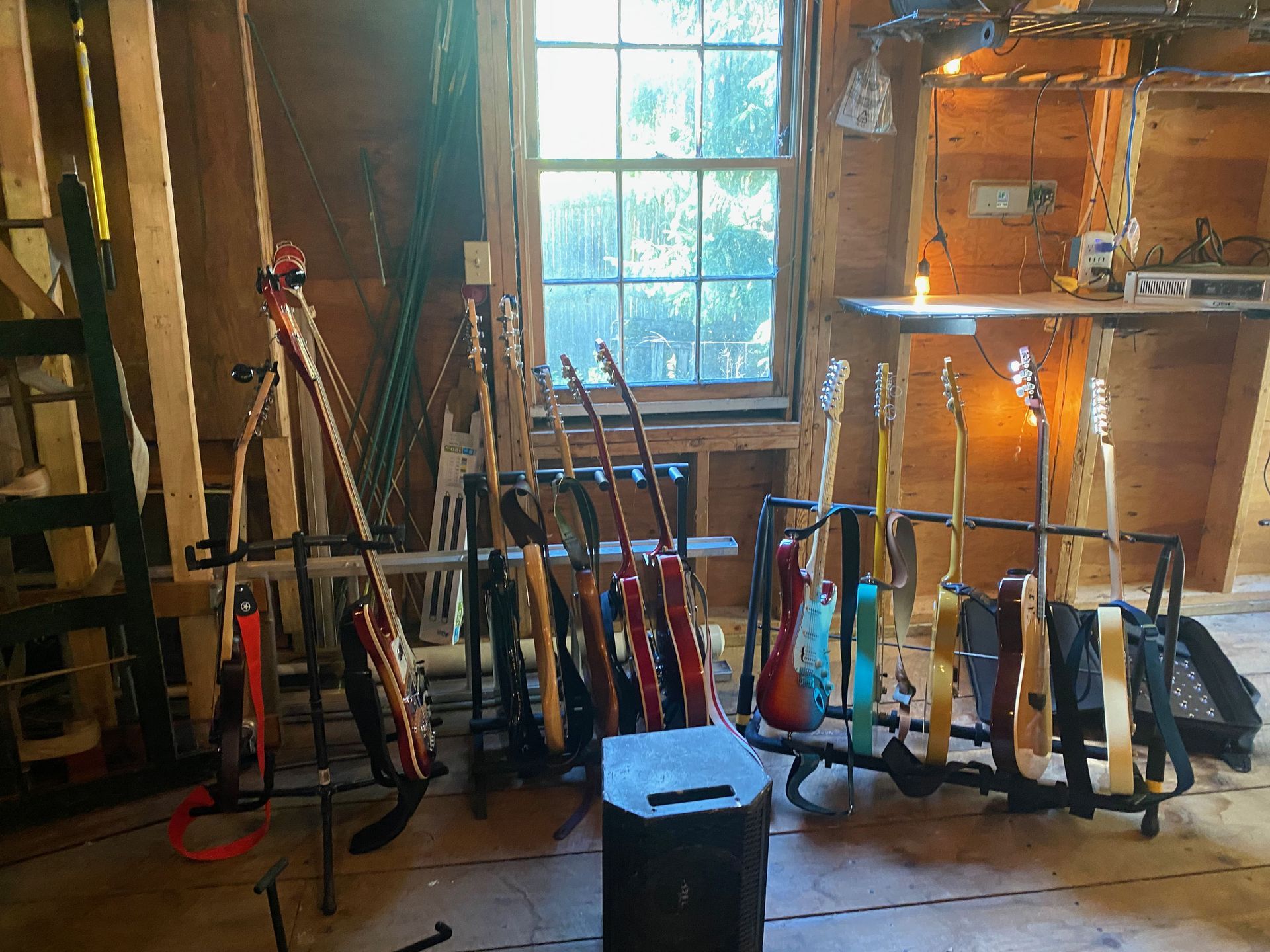 racks with lots of different guitars on it