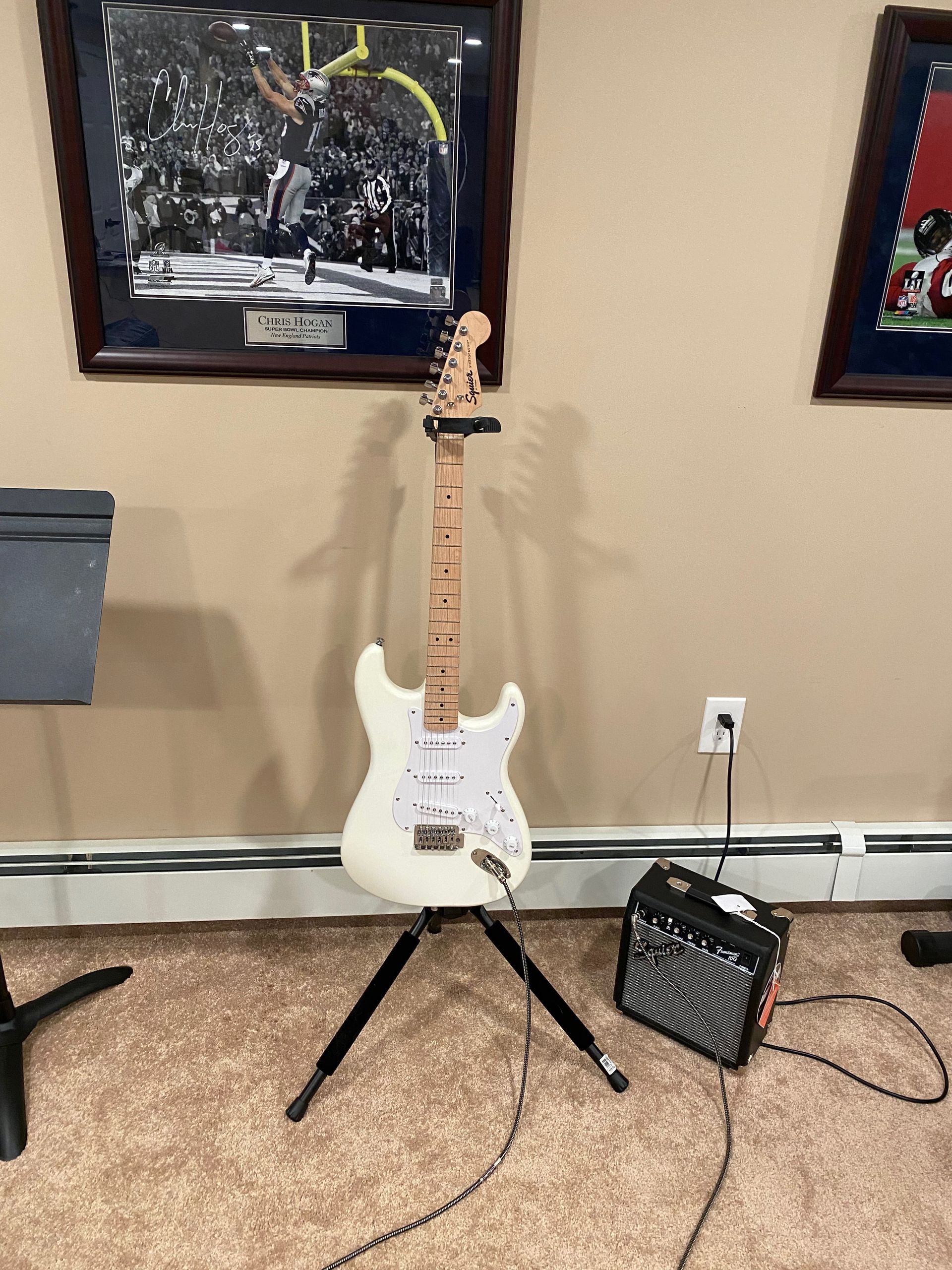 a white electric guitar and an amplifier