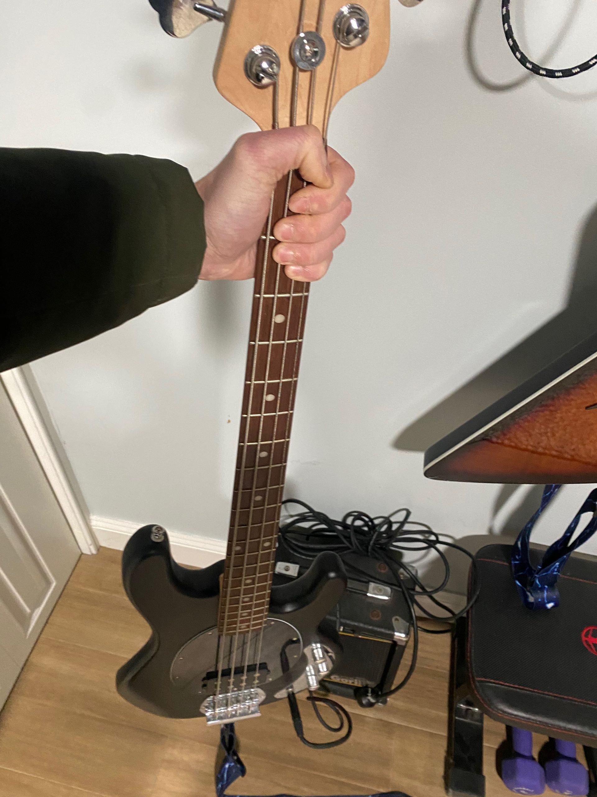 a bass guitar being held