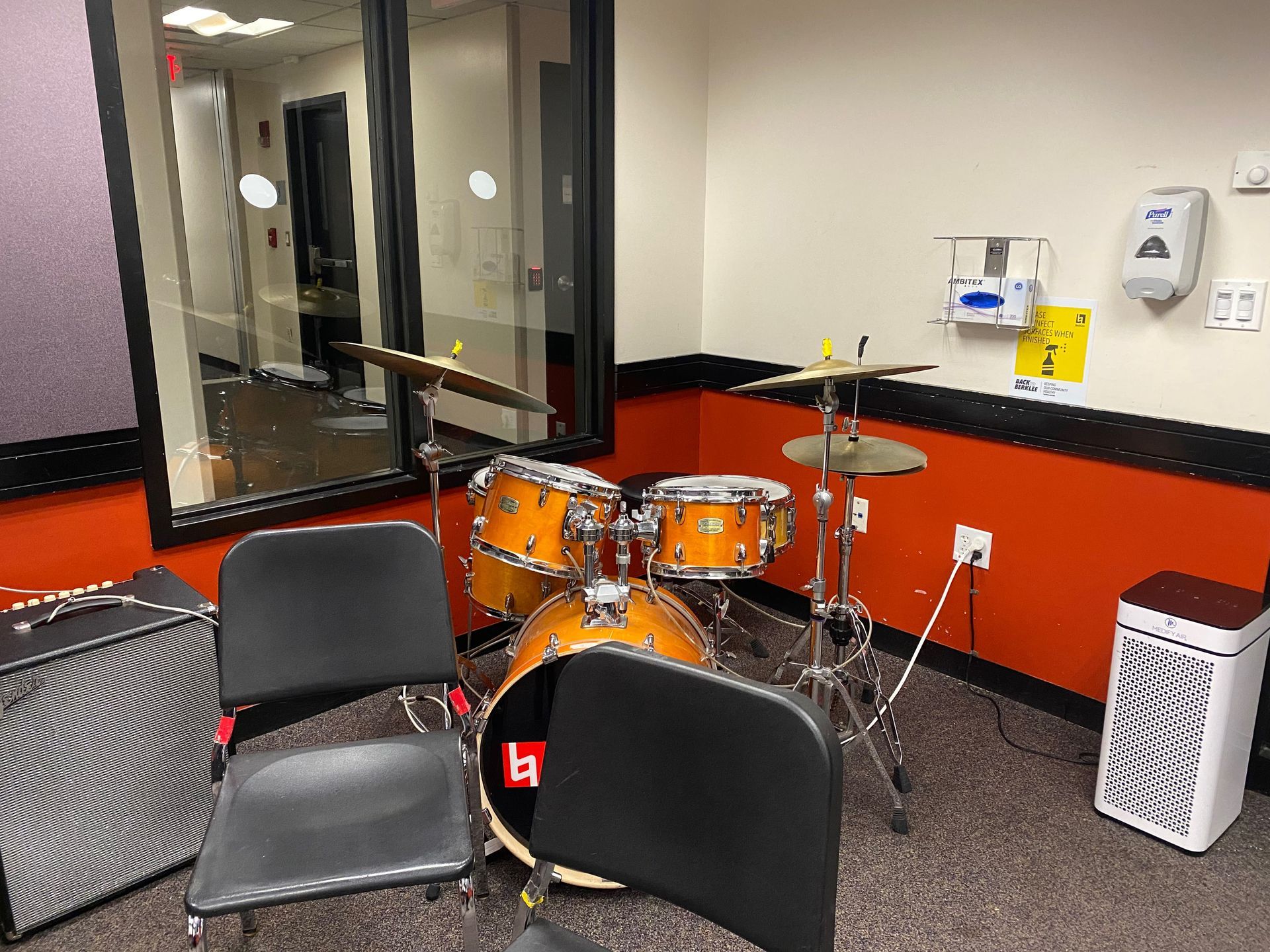 a drum set in a practice room