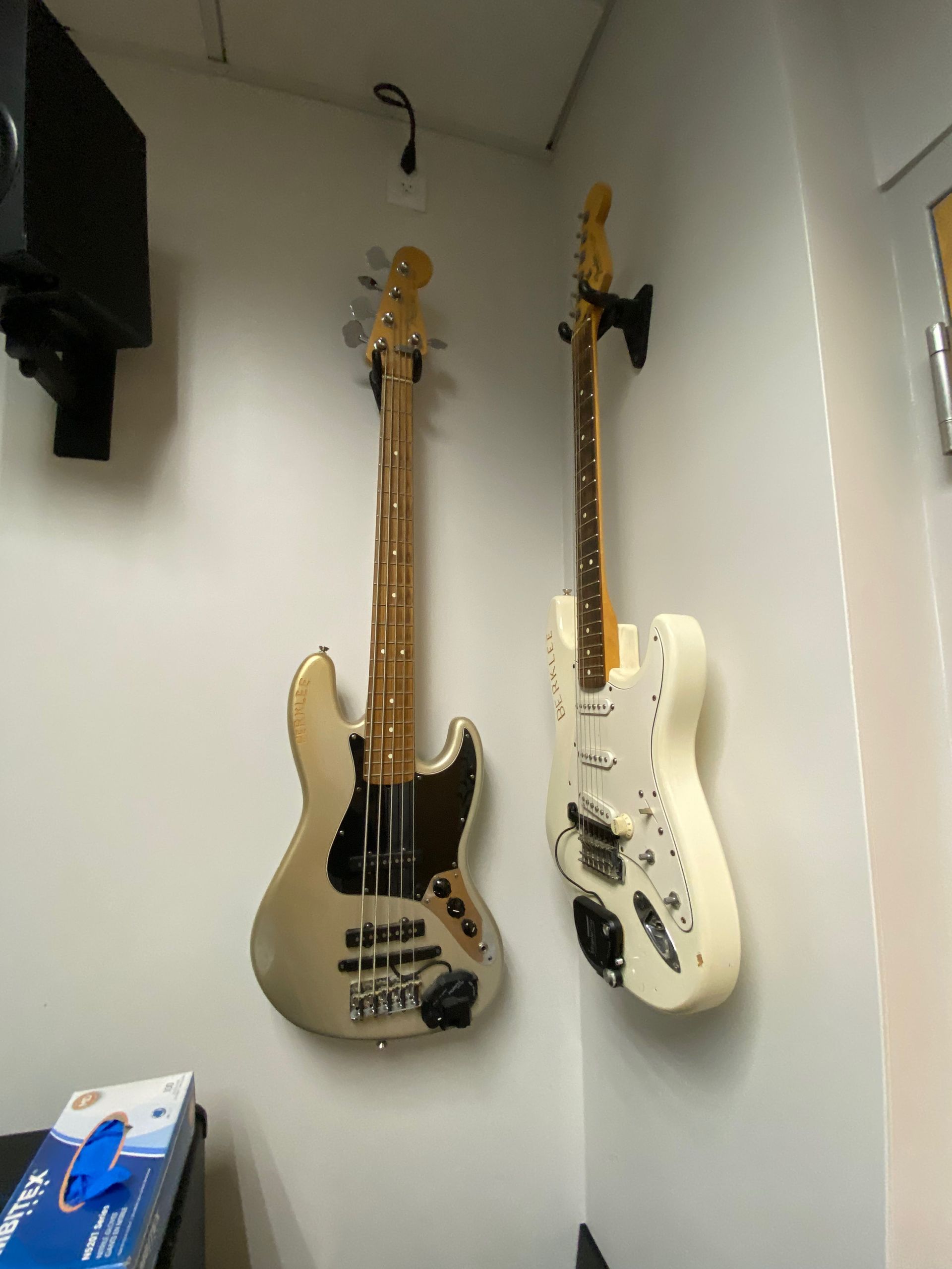 two electric guitars hanging on the wall