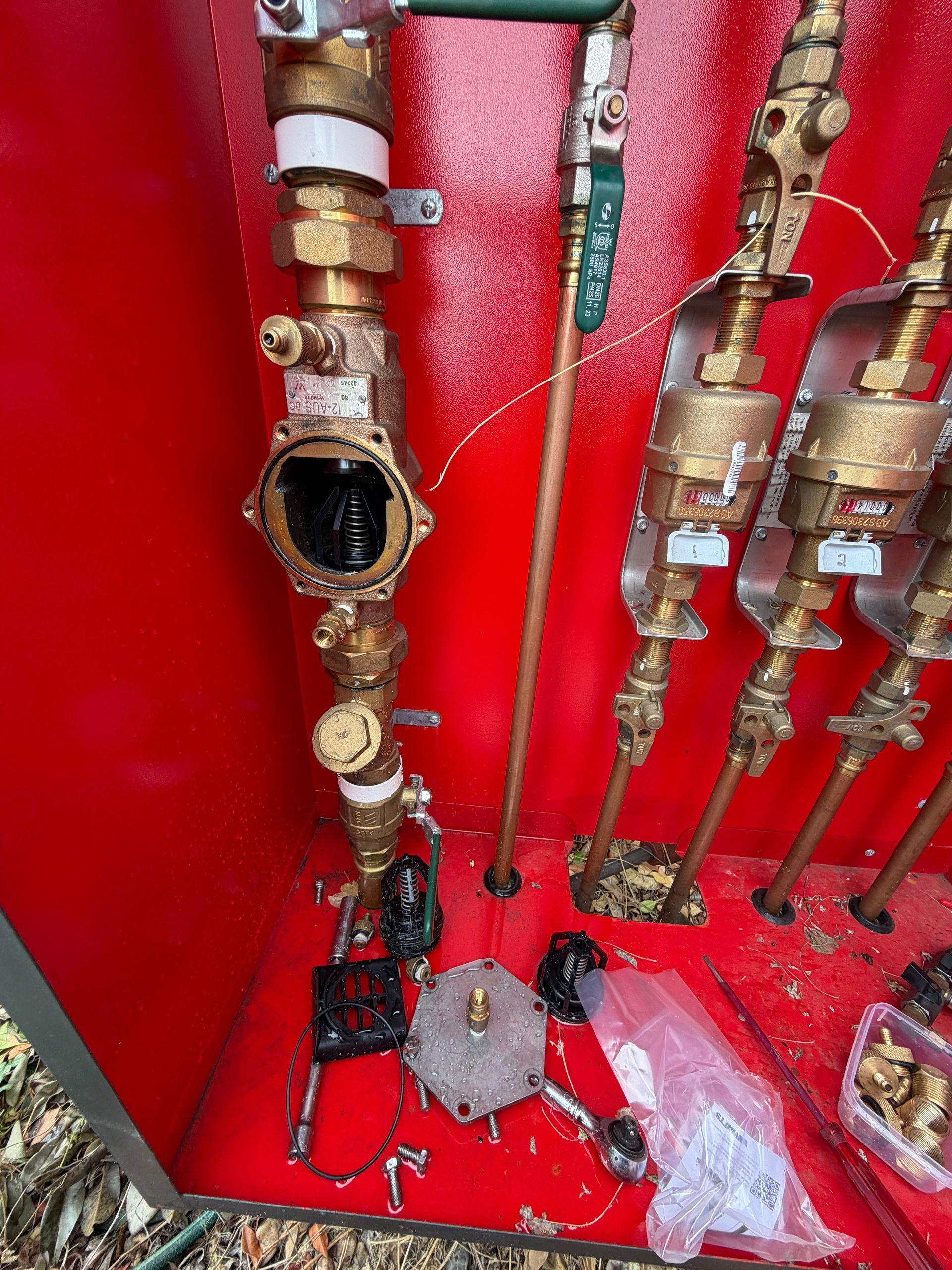 Industrial pipes and valves inside a red utility room — Truflow Plumbing & Gas Solutions in Rockhampton City, QLD