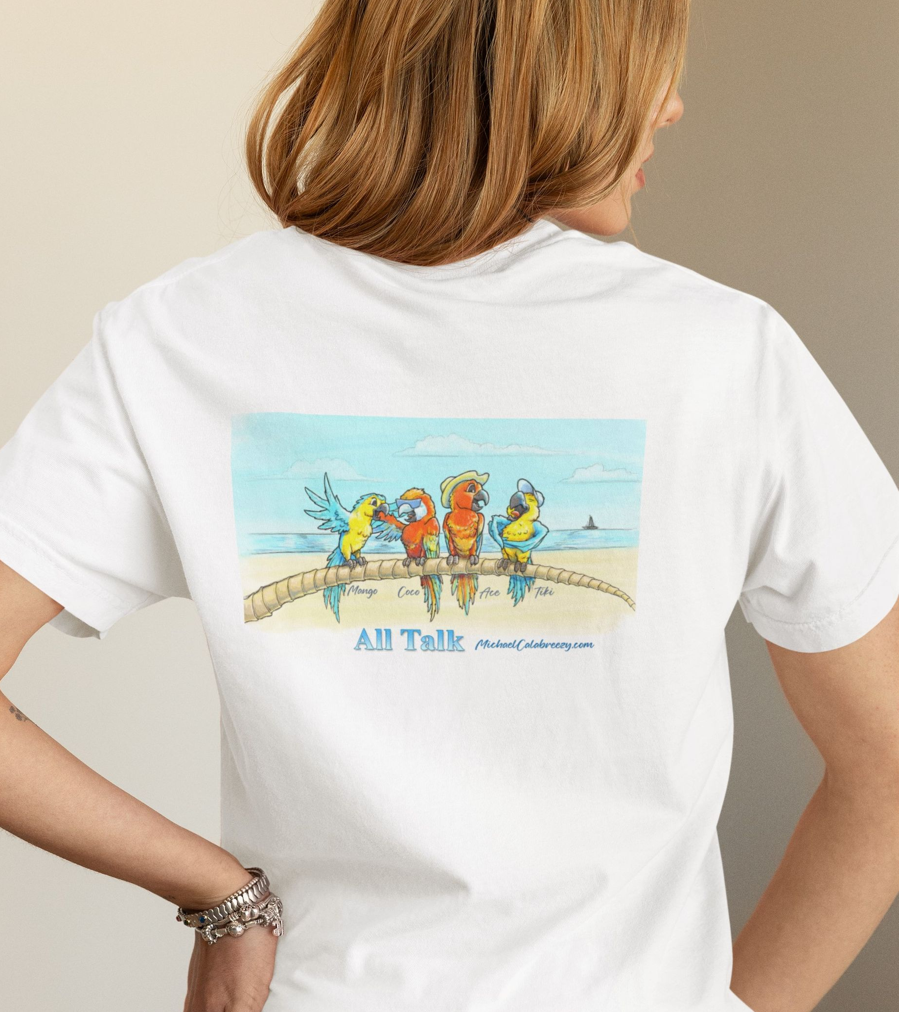 Person wearing a white T-shirt with a colorful beach scene graphic on the back