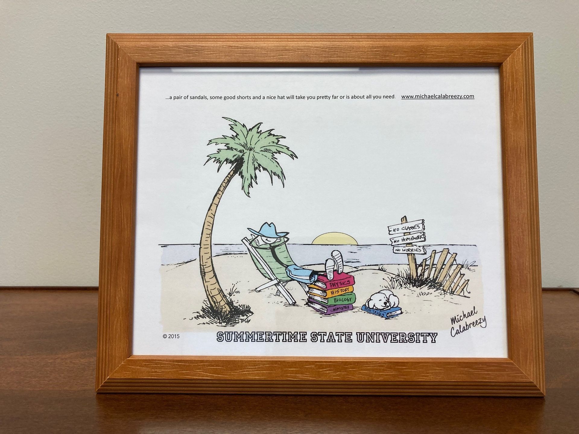 Framed beach cartoon with a palm tree, chair, cooler, and crab on white background