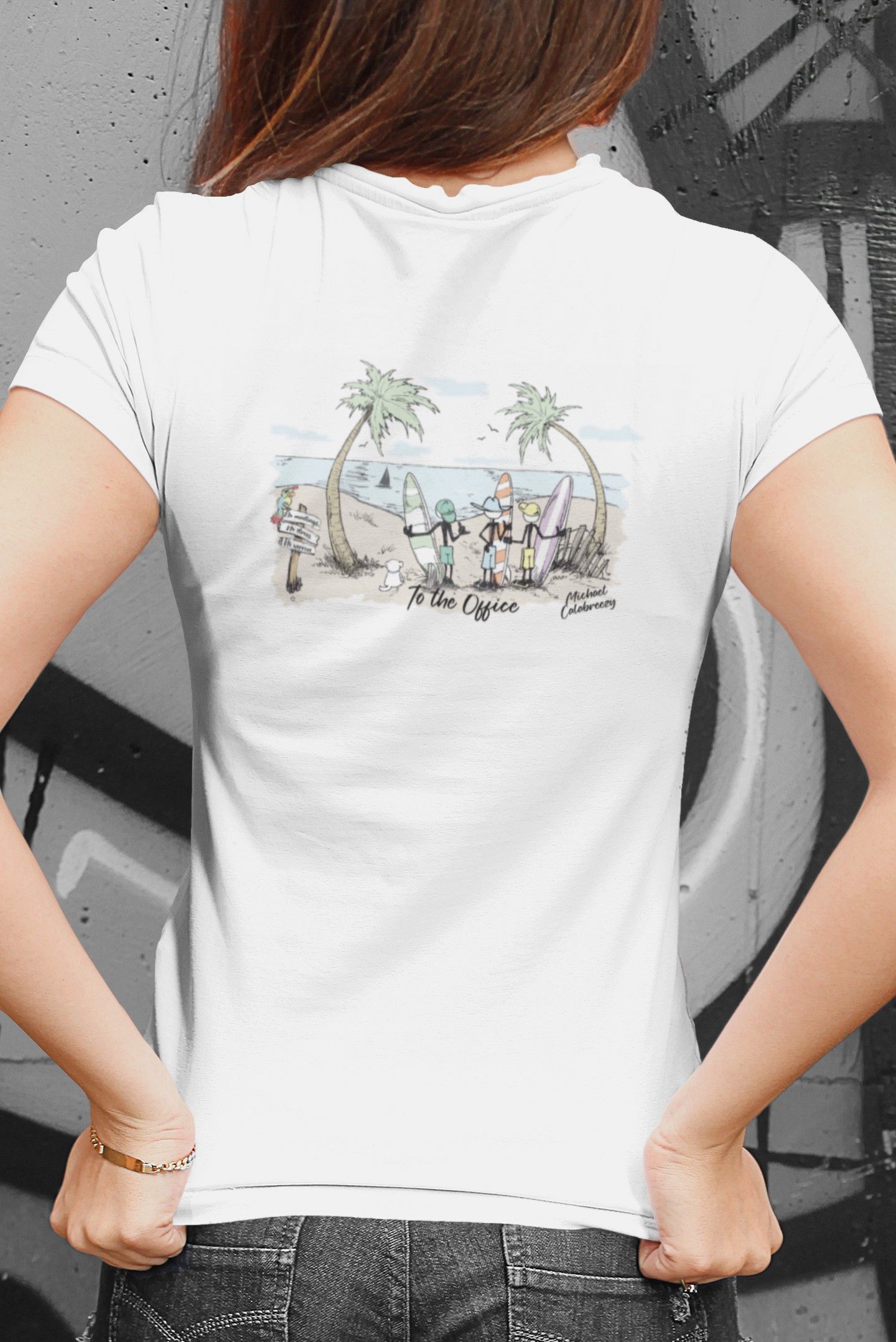 White T-shirt with a small beach scene graphic on the back, worn by a person standing with hands at the hem.