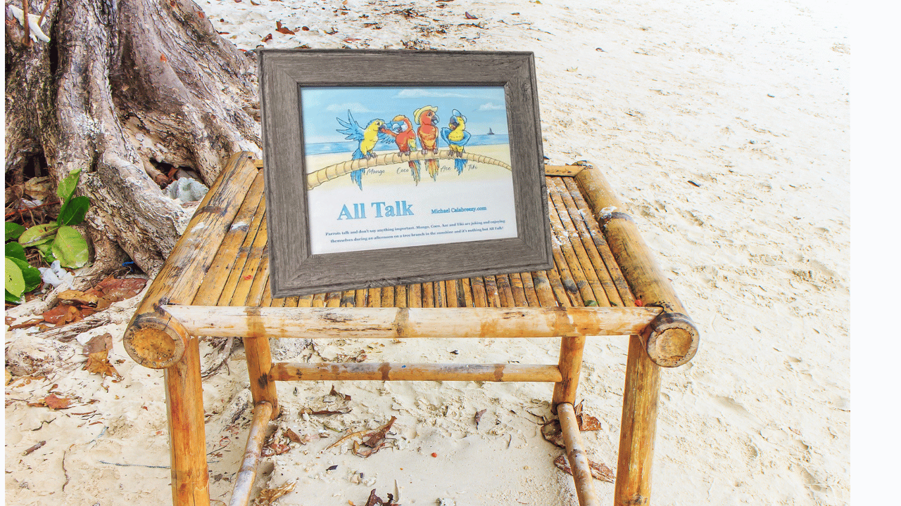 Framed beach sign on a small wooden stool beside palm trees and sand