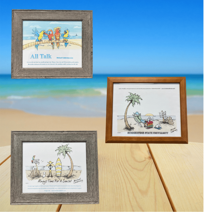 Three framed beach-themed prints on a wooden table with a blue sky and ocean backdrop