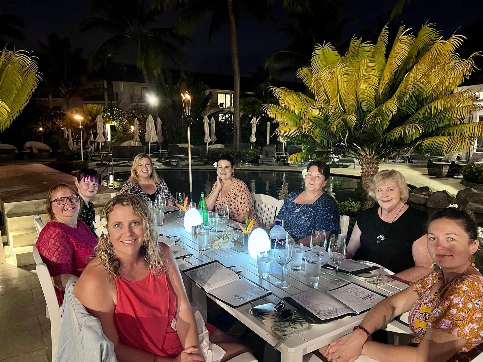 NOWW women having dinner by the pool