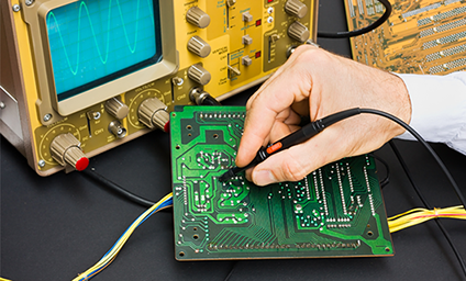 Hand working on a circuit board