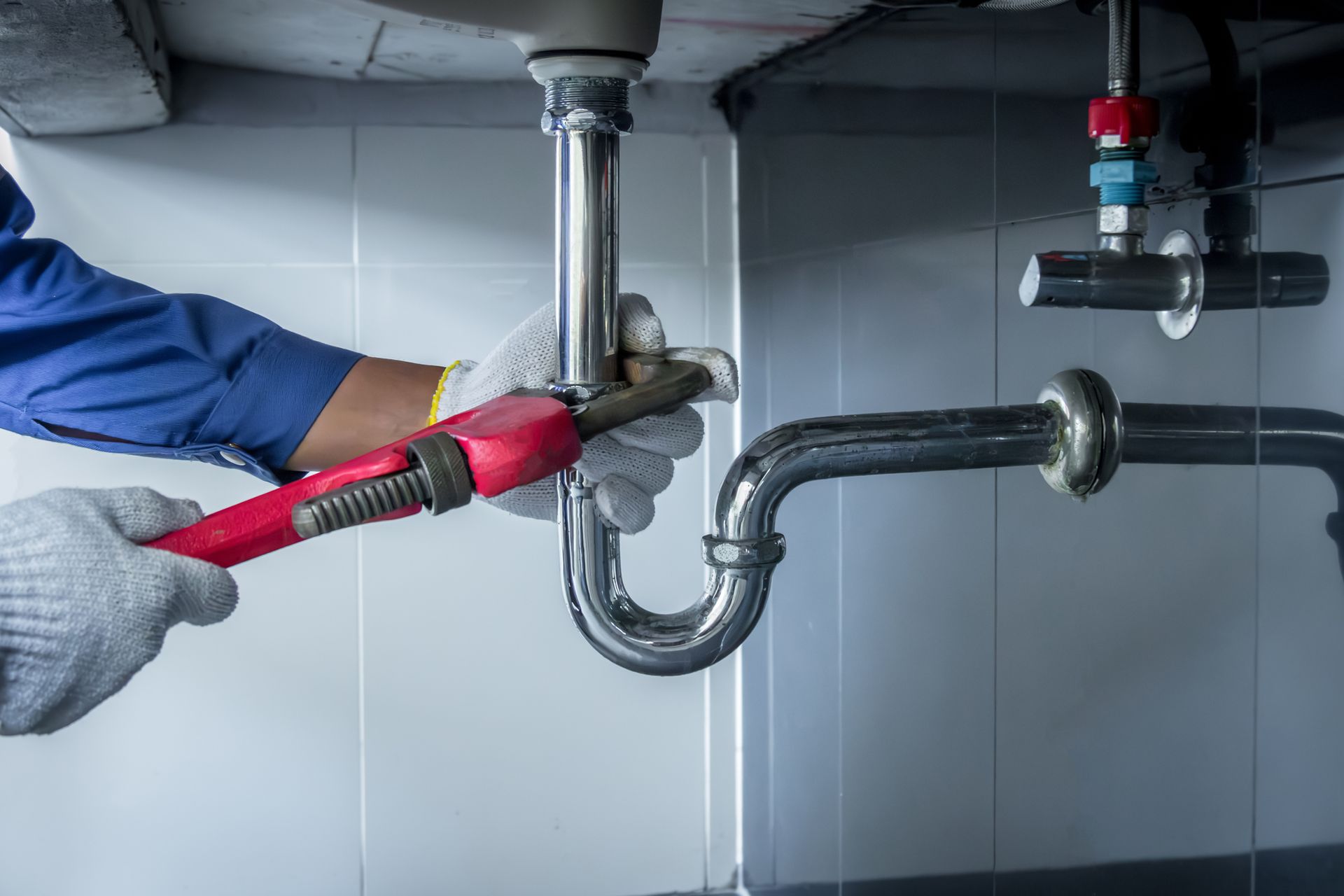 Plumber Fixing a Leaking Bathtub Fixture — Destin, FL — Royce Plumbing & Gas