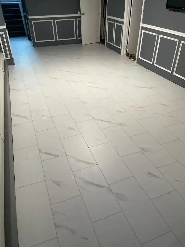 Empty hallway with white marble floor and dark paneled walls along both sides