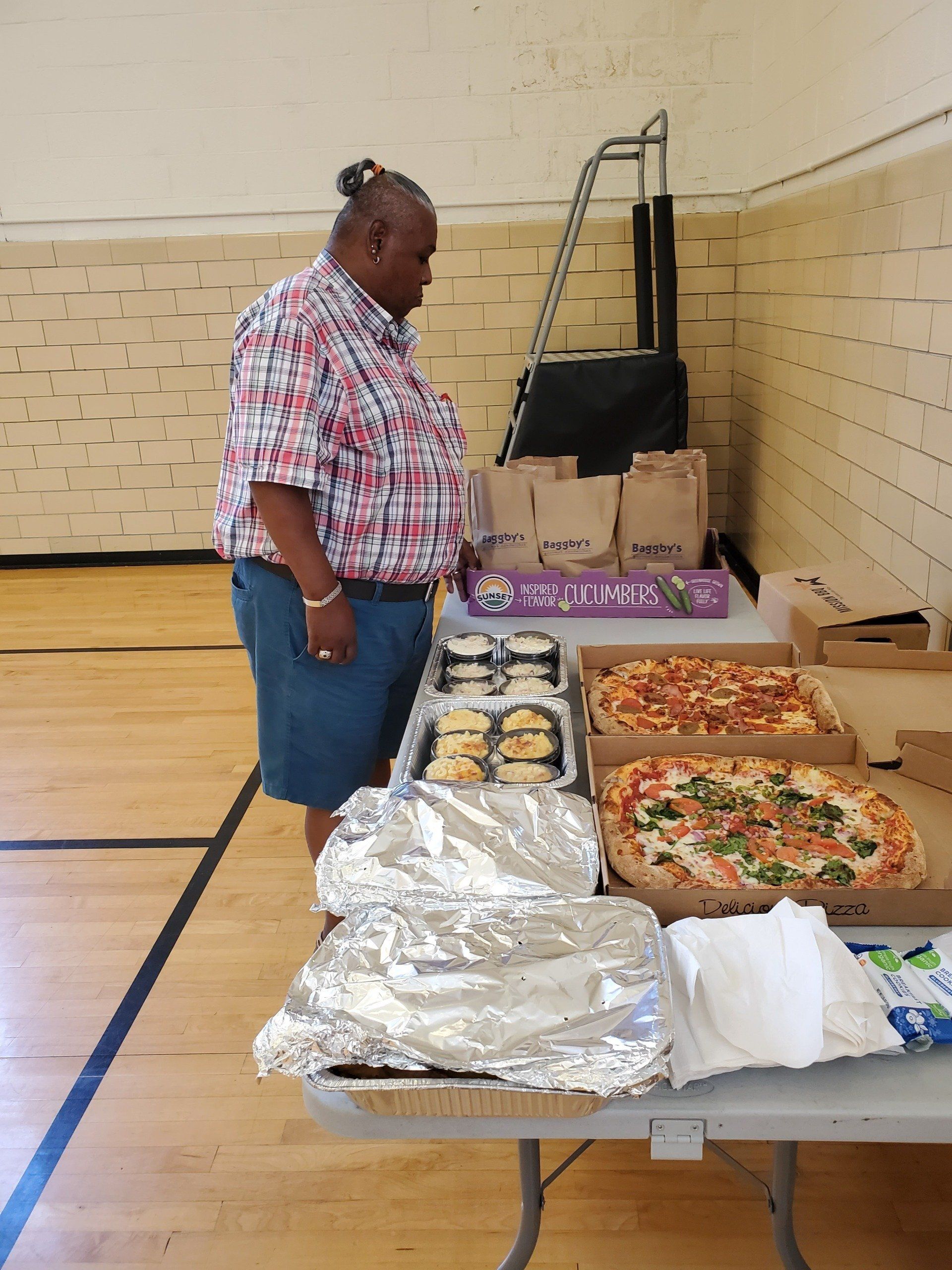 A man standing in front of a table full of food