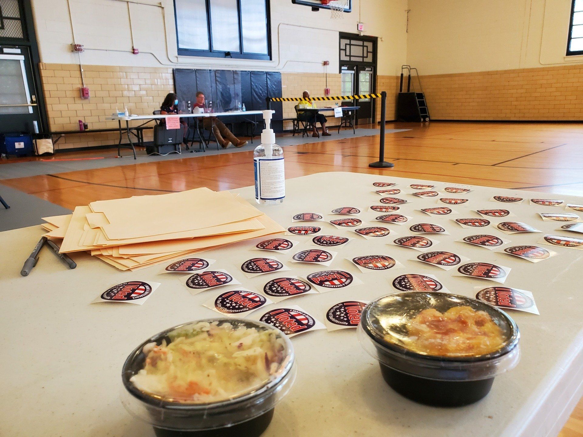 Two bowls of food are sitting on a table in a gym.