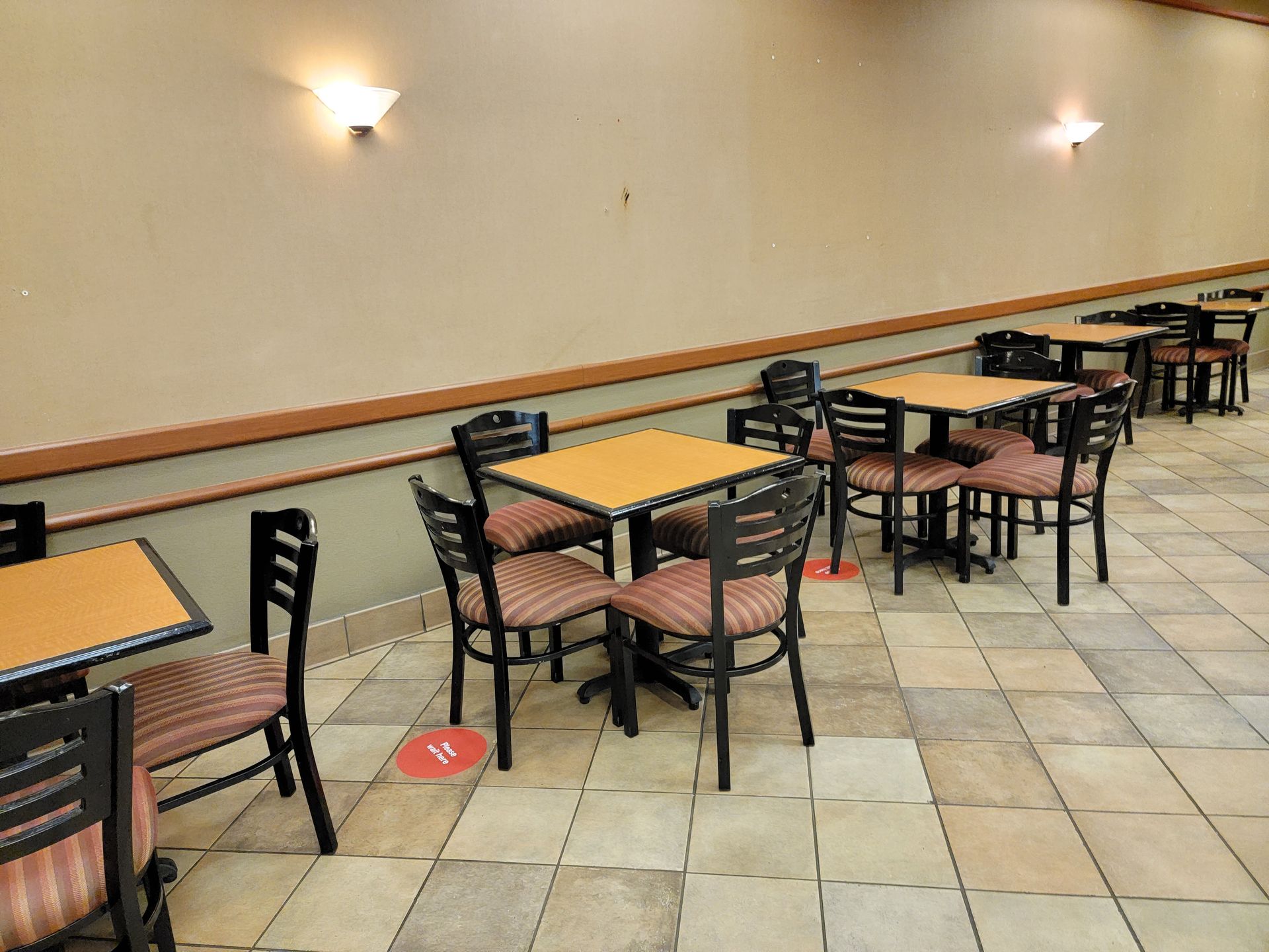 A row of tables and chairs in a restaurant