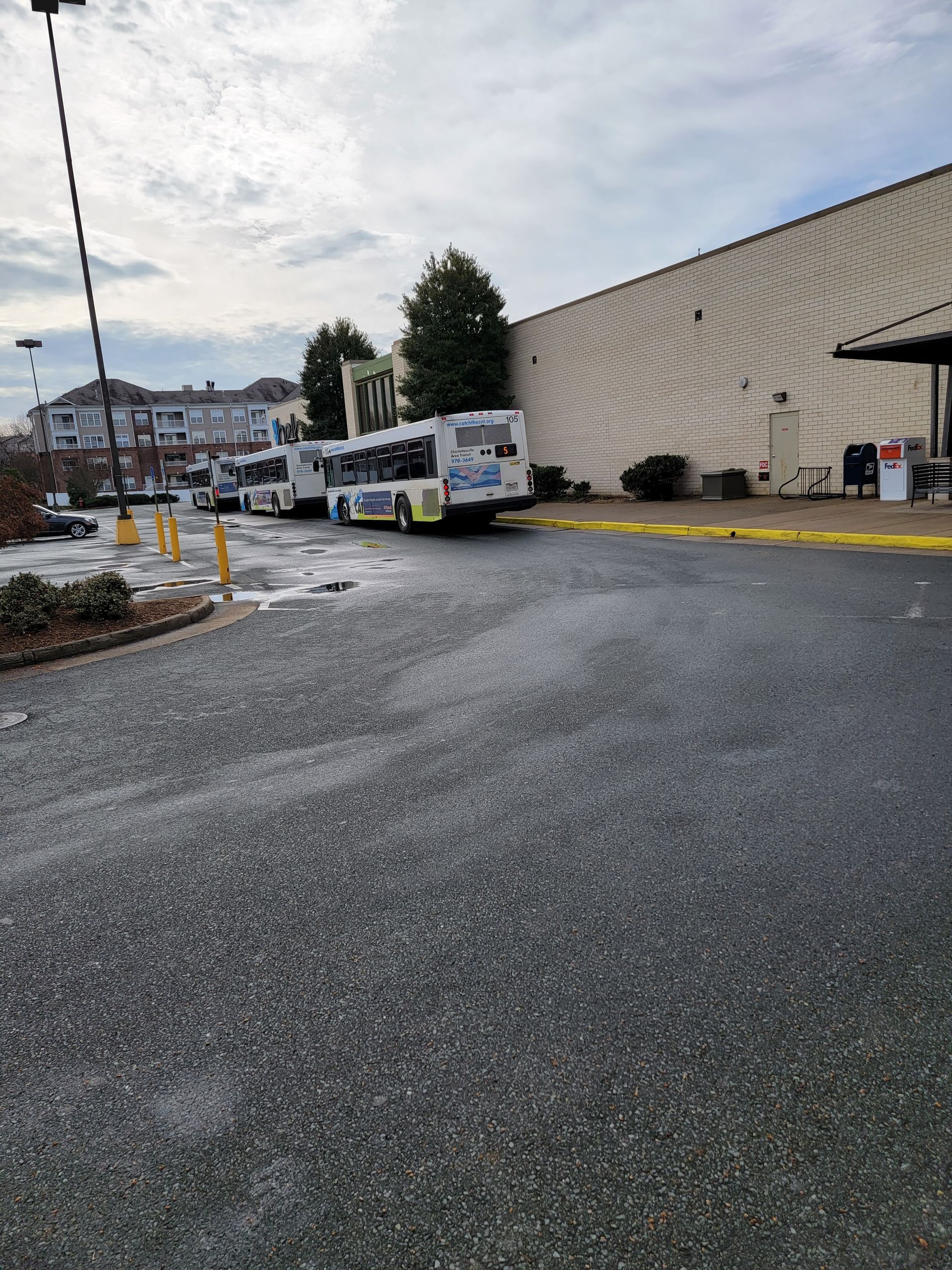 A row of buses are parked in front of a building