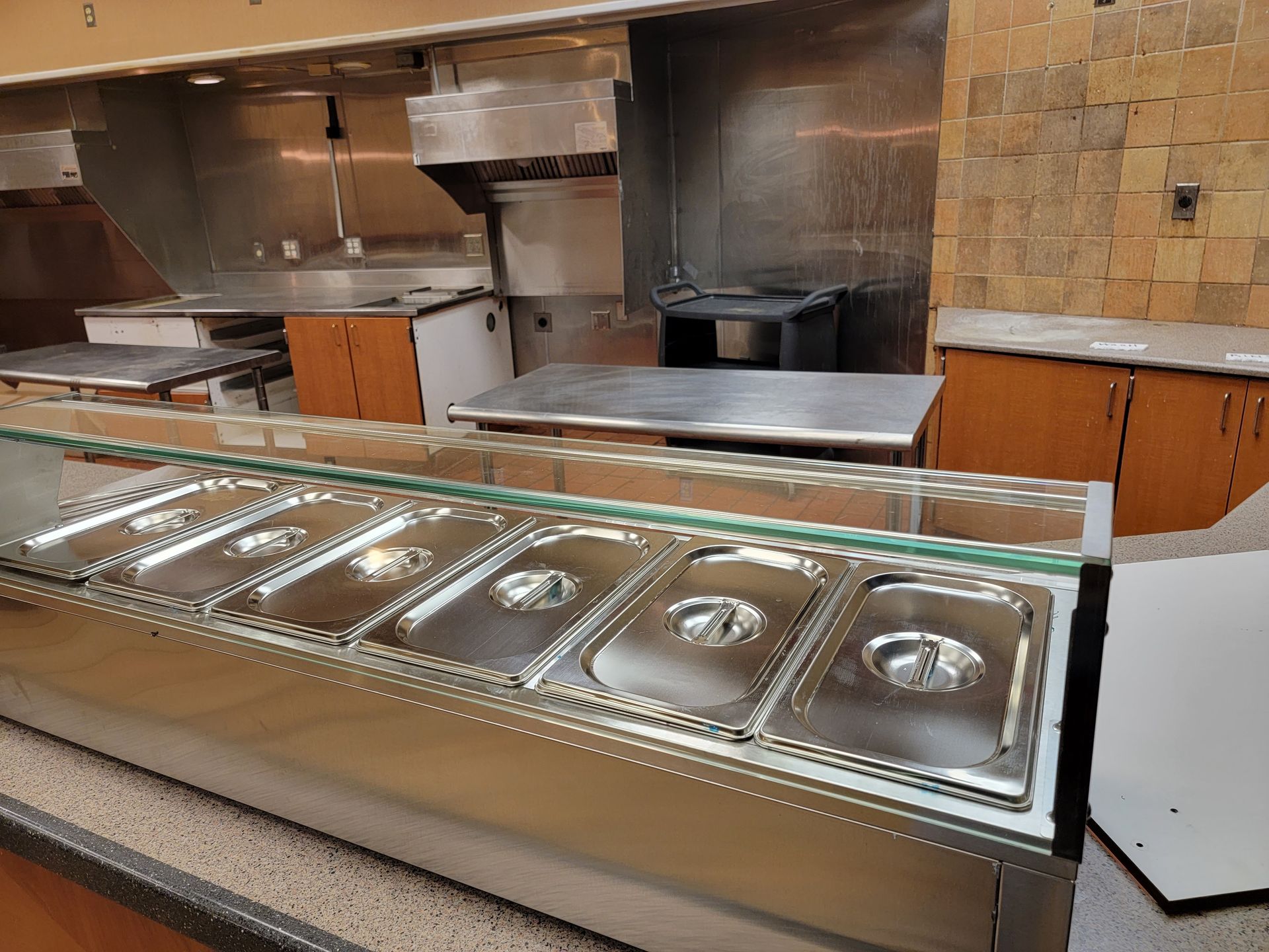 A stainless steel counter with a glass top in a kitchen
