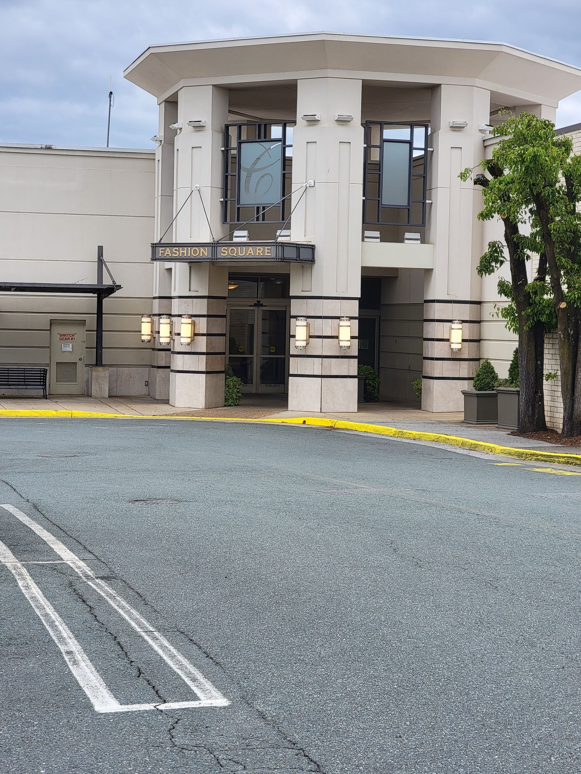 A large white building with a parking lot in front of it