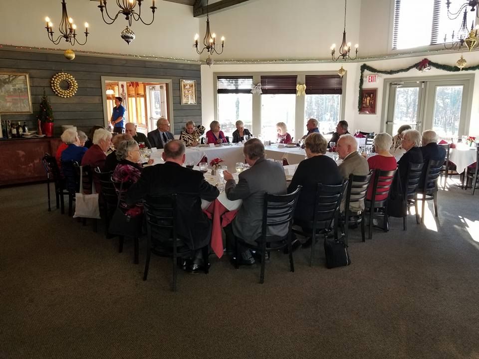 A group of people are sitting around a table in a room