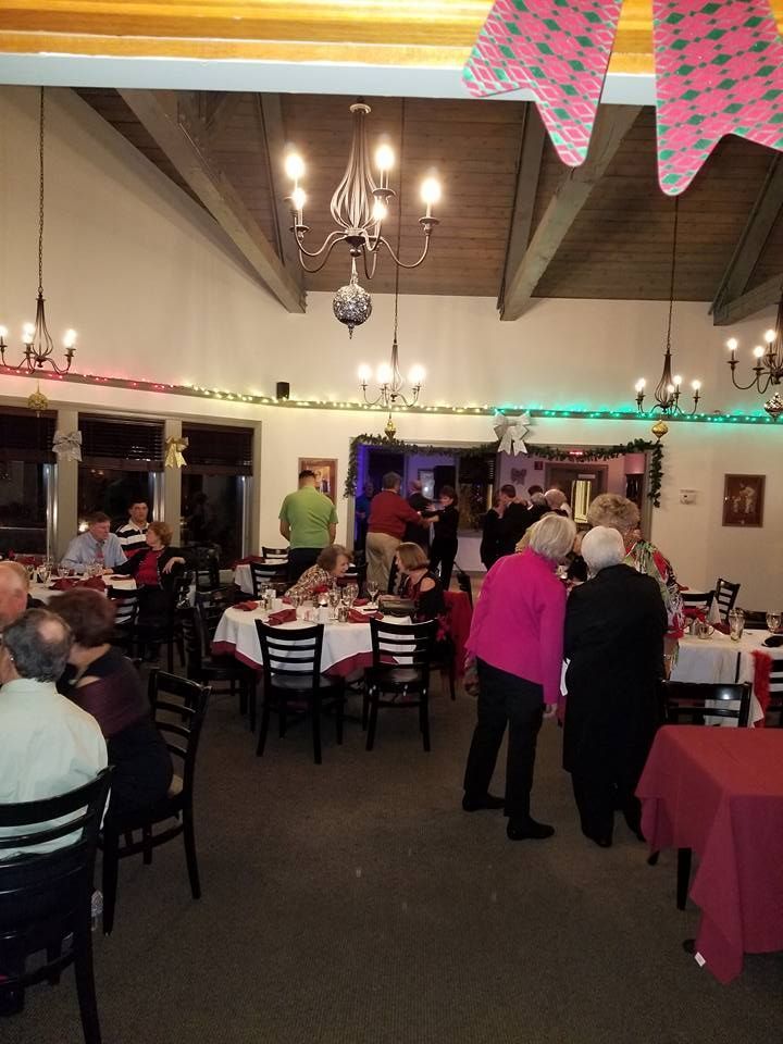 A group of people are sitting at tables in a restaurant