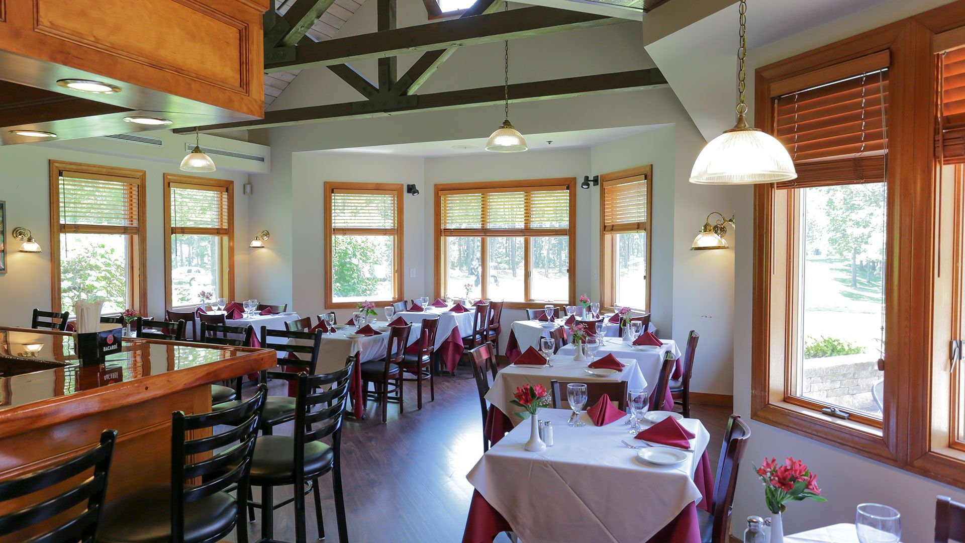 A restaurant with tables and chairs and a bar