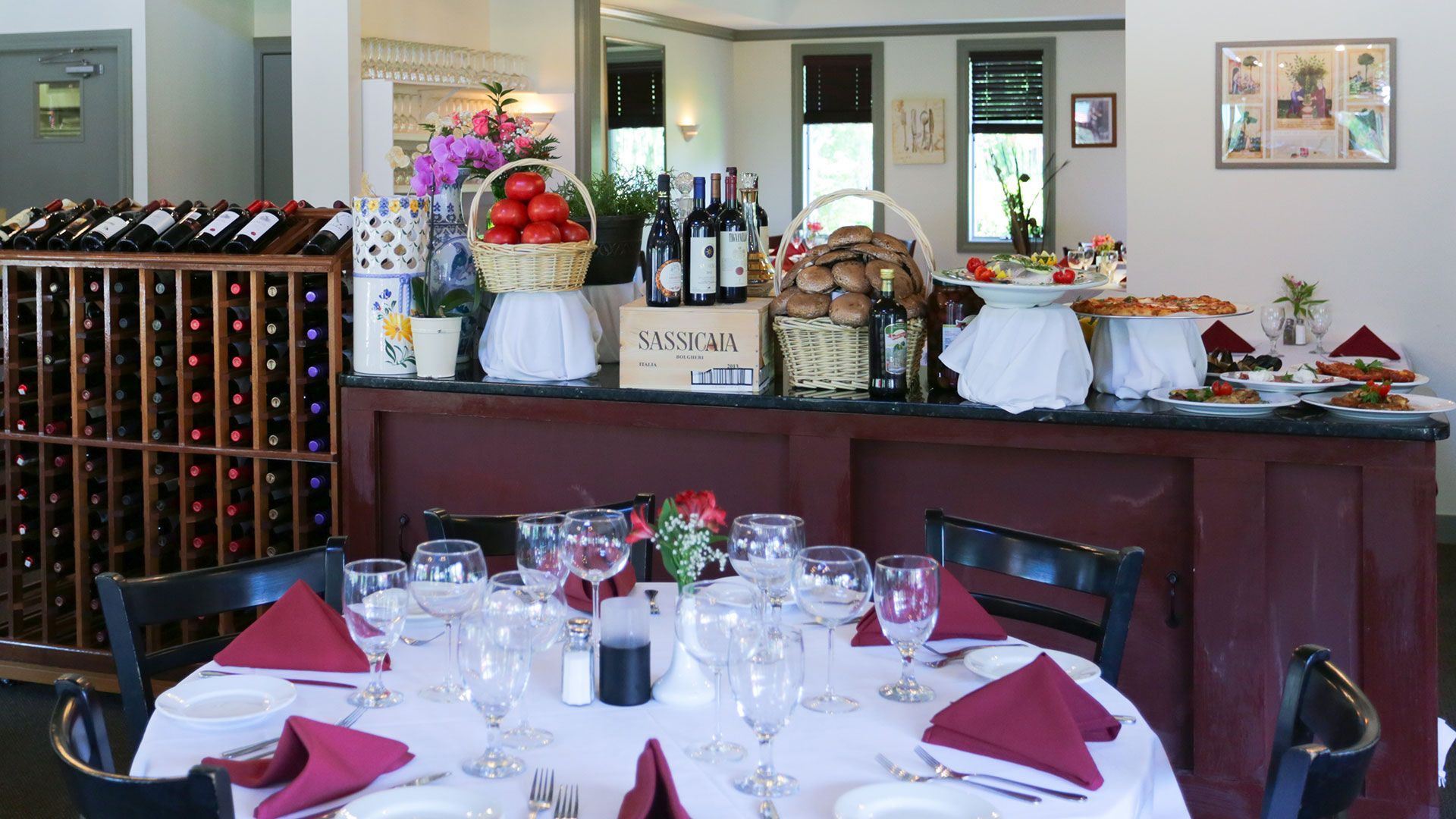 A restaurant with a table set with plates and glasses
