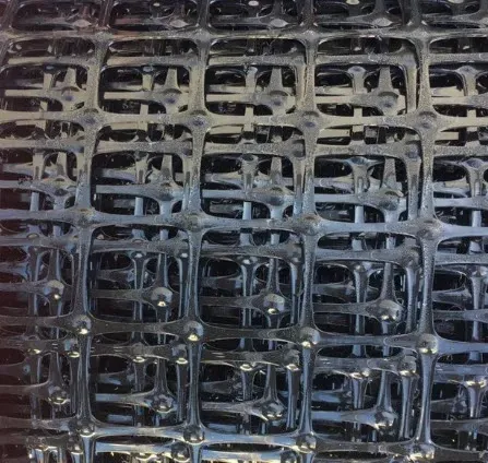 Abstract close-up of a glossy black plastic grid or mesh surface
