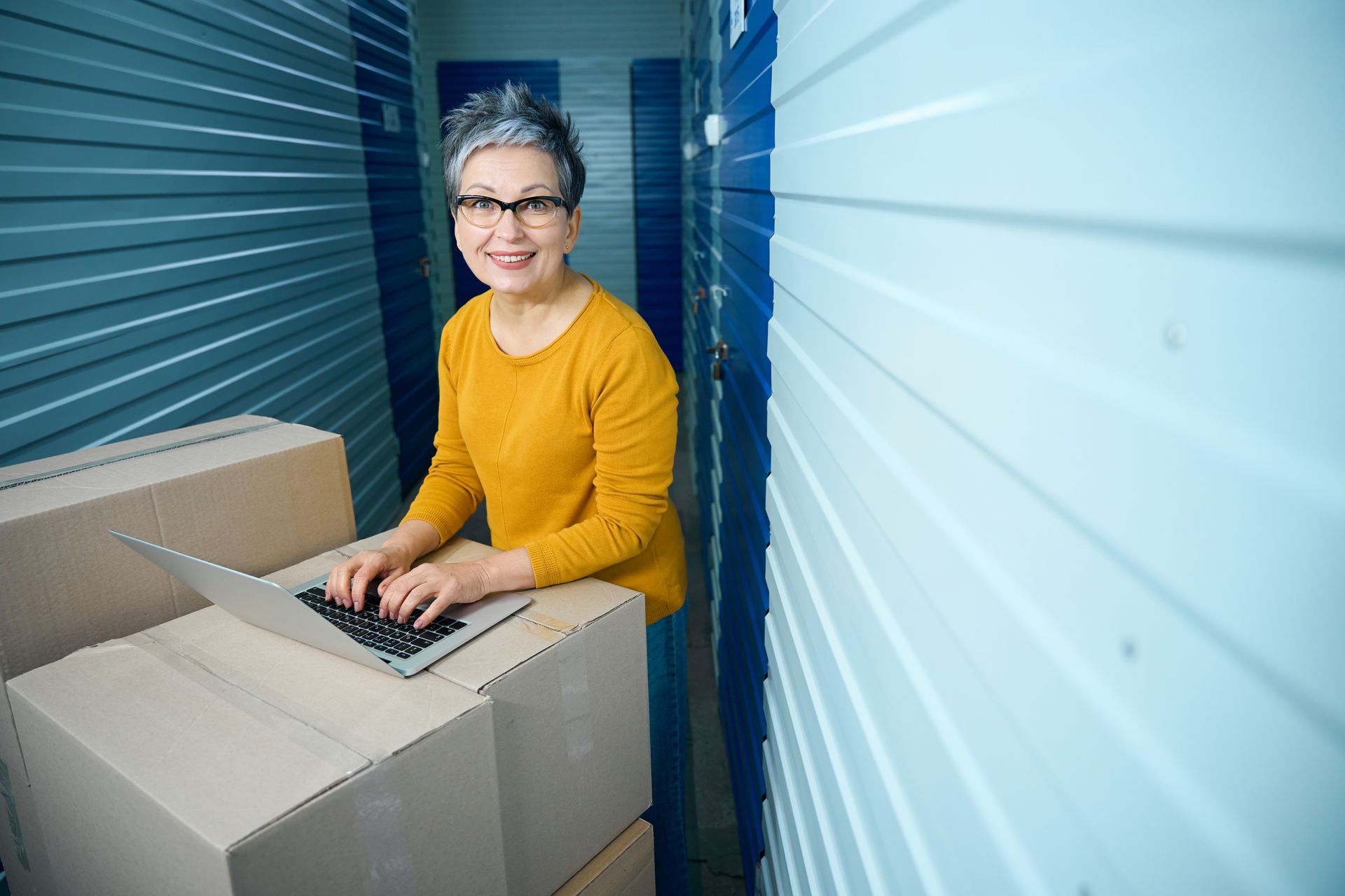 Woman comparing storage unit prices in Little Rock, AR, online.