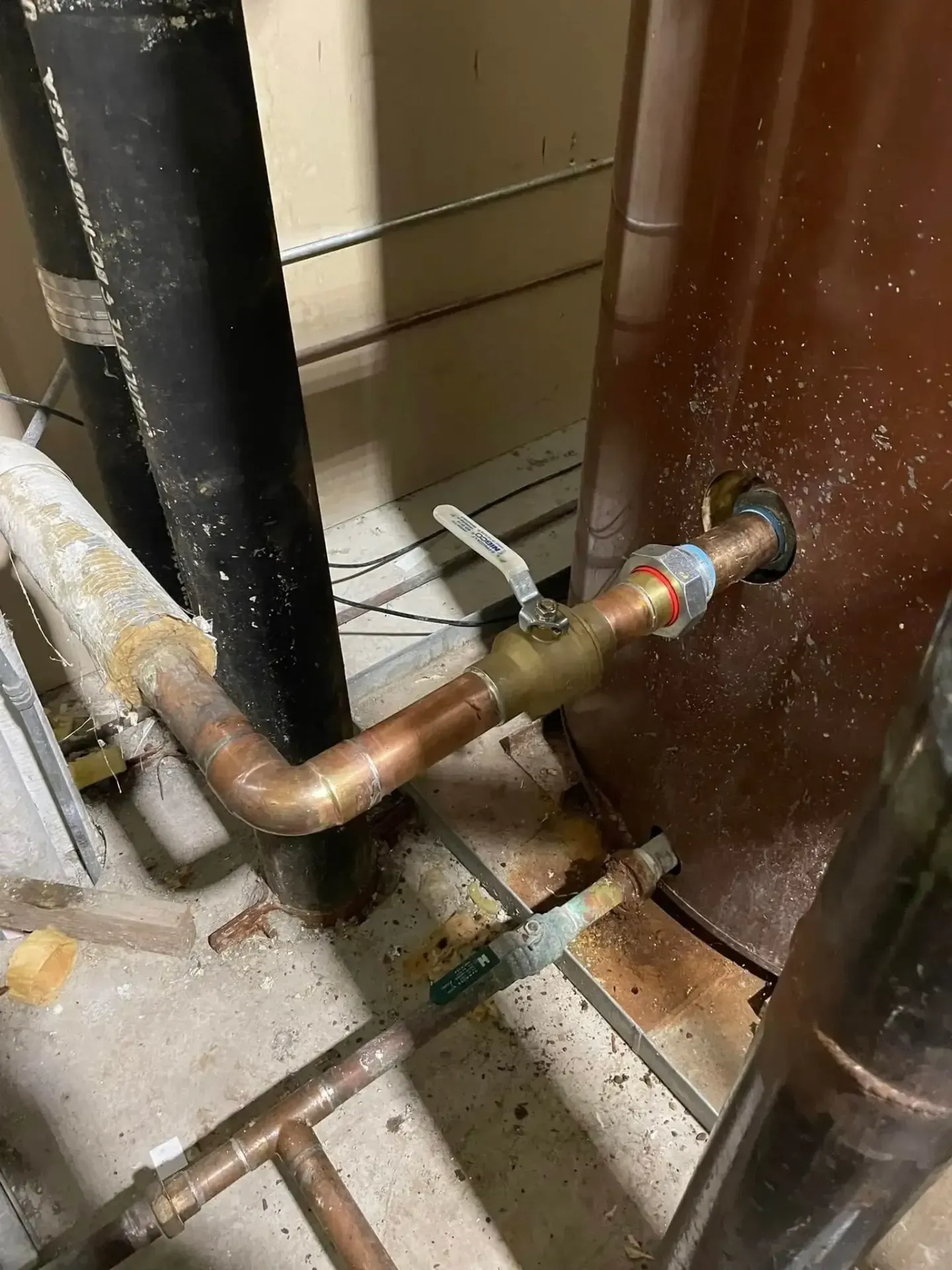 Copper pipes connected to water tank with valve
