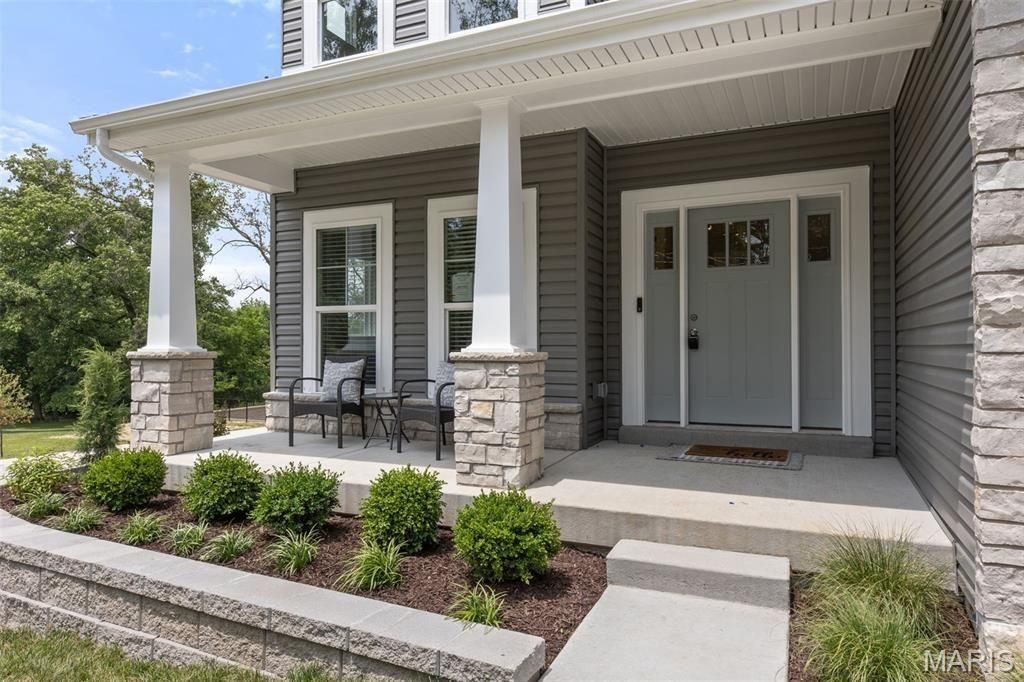 The front of a house with a porch and stairs