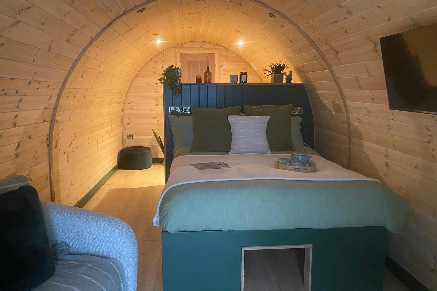 Cozy arched bedroom with a bed, warm lighting, and a built-in alcove ceiling.
