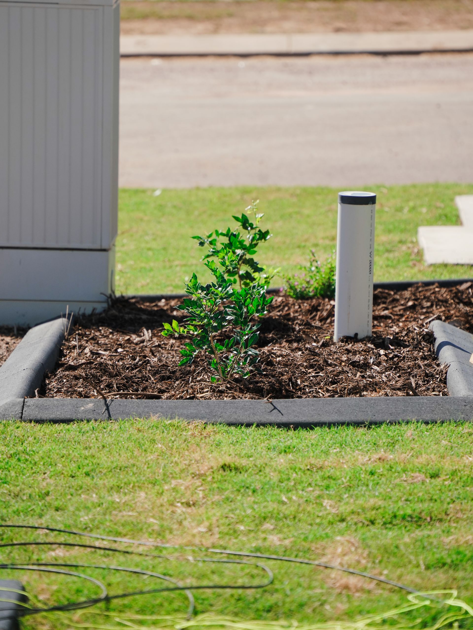 Kerbing Along Grass and Pebbles — Landscaping in Palmerston, NT