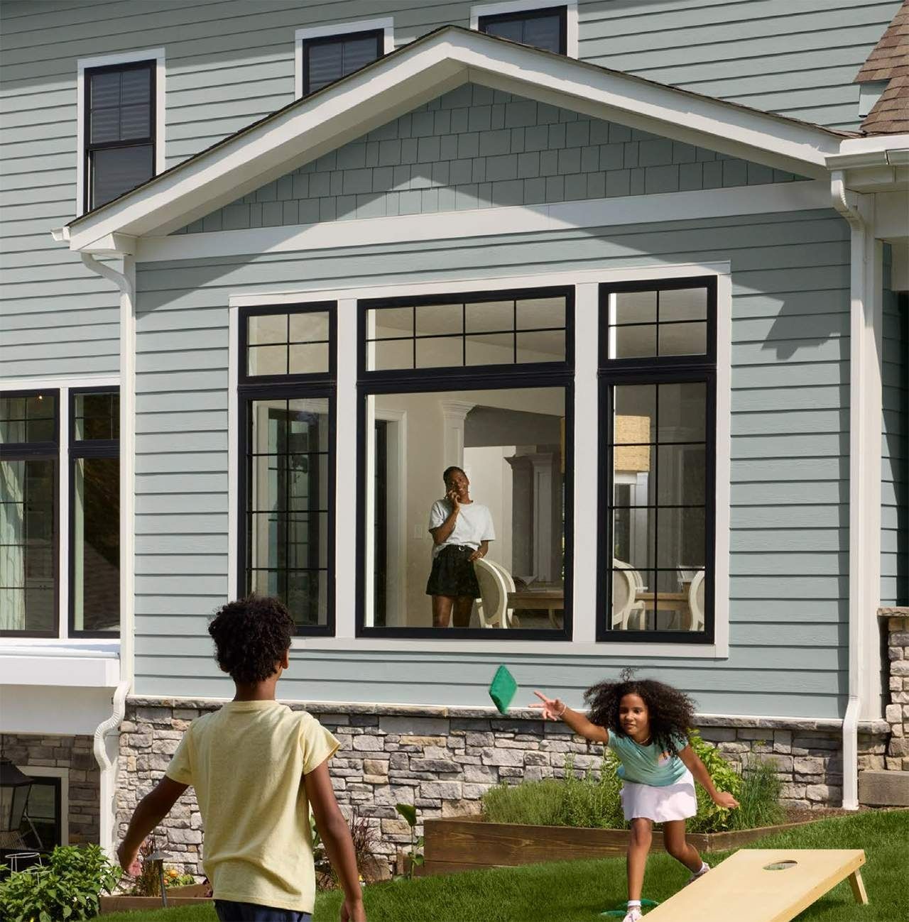 Blue industrial compressor unit in a factory with pipes and metal machinery nearby