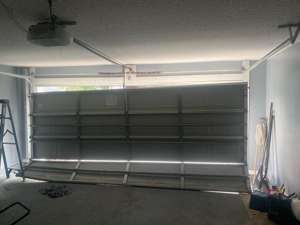 Interior view of a residential sectional garage door and opener