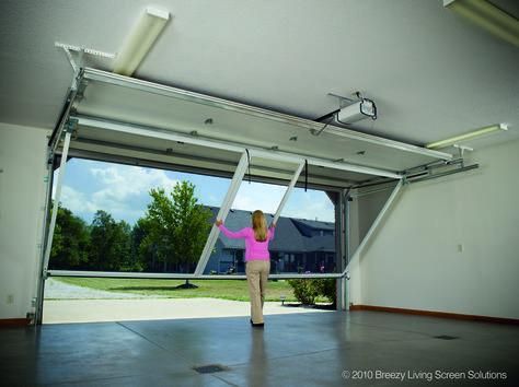 Interior view of an open sectional garage door and its overhead track