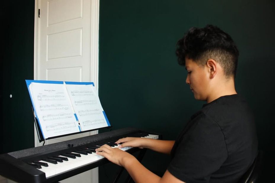 Young student playing piano.